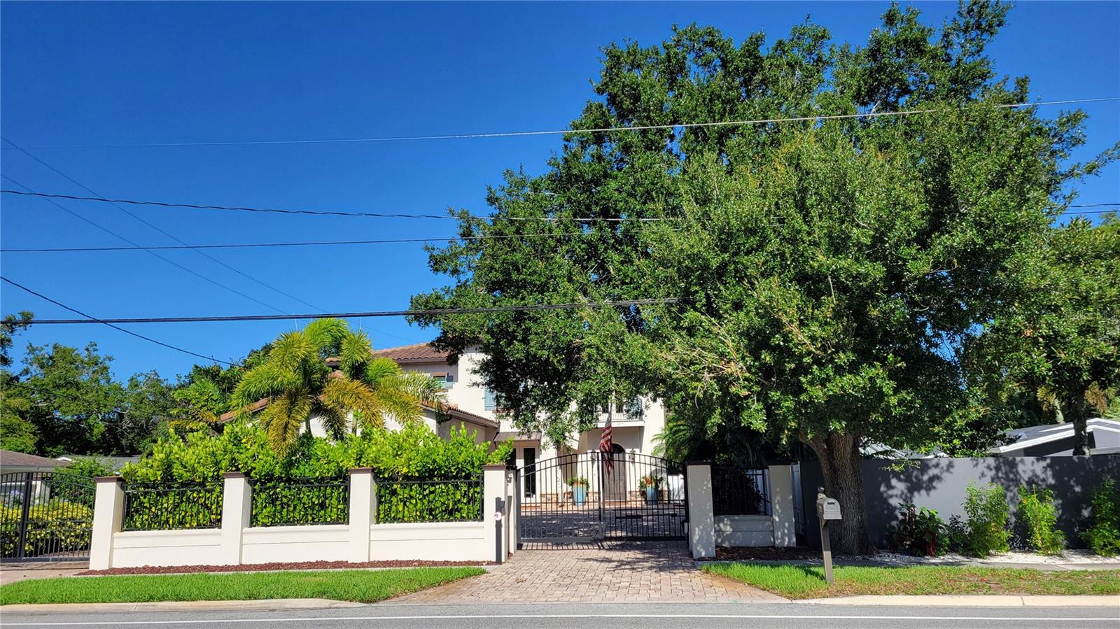 Seasonal and short term rental This gated beauty is IMPRESSIVE. It's easy to see why this home is an overall Parade of Homes winner! Five bedrooms and four and one half bathrooms of spectacular architecture filled with natural light. The great room has soaring beamed ceilings, built around a massive fireplace and open to the kitchen for easy family time and entertaining. The kitchen boasts solid wooden cabinetry topped with slab granite counters with breakfast bar on huge island. You'll be pleased with a custom backsplash, professional Viking stainless steel appliances, and a water filtration system with softener. The master bedroom is on the main floor with two large closets, en-suite bathroom with dual vanities, garden tub, water closet and walk in shower. There is also a 2nd bedroom on the main floor with attached full bathroom. Upstairs you'll find a large loft style family room with big screen TV, three more bedrooms with en-suite bathrooms and a sun deck overlooking the heated pool and outdoor entertainment space. The flooring is all solid surface-tile, and Brazilian wood flooring so NO CARPETING. The outdoor entertainment area is built around a large pool with fountains, covered seating area with fire pit and summer kitchen with al 'fresco' dining options, fireplace and lush landscaping with privacy fencing. This wonderful home is very close to Siesta Key, the #1 beach in the country, fine and casual dining, shopping, and downtown Sarasota with the opera, theater, and museums. There is garage parking for one vehicle and an electric car charging station. Now rented thru July 30 2025. Call today for your next vacation!