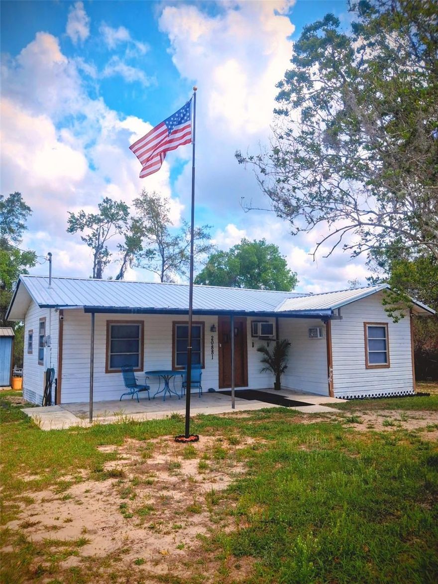 A traditional CABIN in the WOODS! Comes with a covered porch where you can enjoy the breeze and a rocking chair too! This home is in the Ocala National Forest so expect unmaintained dirt roads on your drive in.  This precious cabin allows for privacy, hunting and lots of it, dirt bikes and off road enjoyment. Home has a metal roof.  Sits on (4) parcels which can be seperated. Can be a full time home, part time for sports or Florida getaway or even a short term rental for hunters!  Additional interior photos available after 4.9.2026