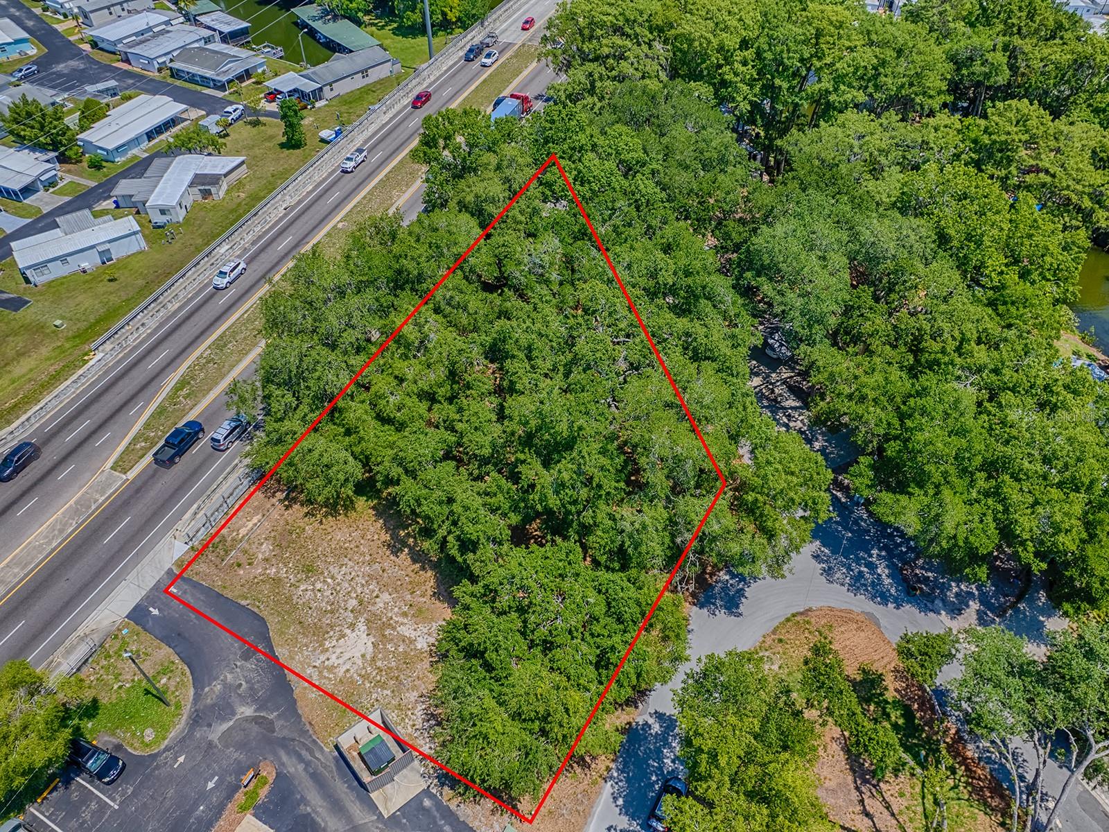 EXACTLY WHAT YOU'RE LOOKING FOR! EXCEPTIONAL .59-ACRE VACANT LOT ZONED MU (Mixed Use Commercial) in the heart of “America’s Seaplane City” – Tavares, Florida. High and dry, this property offers prime visibility next to busy Dunkin’ Donuts at the intersection of State Road 19 (S. Duncan Dr) and Lake Harris Dr (Dead River Rd on west side).
Located on a heavily traveled 4-lane divided highway (SR-19) near the Dora Canal—a waterway connecting Lake Dora and Lake Eustis. This is a high-traffic corridor just south of US Hwy 441 (Orange Blossom Trail/OBT) in a rapidly growing commercial district.
Key Features: Zoned MU – ideal for professional offices, retail, storage units, salon, coffee shop & more. Two points of ingress/egress: one on SR-19, another on Lion Ln, with potential third on Forest Dr. Survey with topography available. Outstanding visibility and location with strong daily traffic counts of over 36,000 (+) (AADT)/(FDOT). Close to shopping, restaurants, executive airport, boat ramps, and major highways. Approx. 1 hour to Orlando International Airport, Disney, Universal, and East/West coast beaches. The City of Tavares is highly responsive for permitting—send a concept sketch for feedback. Preferred structure style includes A-line roofing (note Dunkin’s tile roof next door). Near schools, The Big House sports facility, and AdventHealth Waterman Hospital (approx. 3 miles away). This area is part of the Golden Triangle (Tavares, Mount Dora, Eustis) and offers a rare opportunity in a location rich in value and potential. Whether for development or investment—land doesn’t depreciate, and this location is everything. Buyer to verify all intended uses with the City of Tavares.
