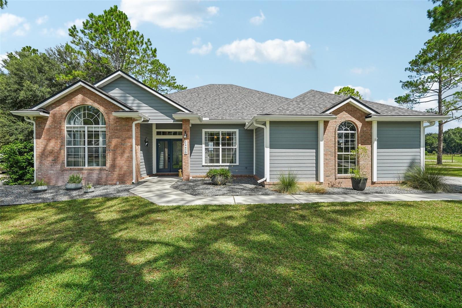 Welcome to this stunning 4-bedroom, 3-bathroom single-family home in High Springs, Florida, offering 2,346 square feet of thoughtfully designed living space on over an acre of beautifully landscaped land. Recently updated, this home features a new roof (Aug 2023), all-new air conditioning (Jan 2024), water heater (Aug 2025), water softener (2023), pool chlorinator (2023), and gutters with guards (2022). The open-concept layout immediately welcomes you with a bright, spacious living room showcasing built-in shelving, a fireplace, and an abundance of natural light. With tile flooring throughout, the home offers both style and easy maintenance. The kitchen is a chef’s dream, complete with stainless steel appliances, solid wood cabinets, a breakfast bar island, ample counter space, a walk-in pantry, and an eat-in area, complemented by a formal dining room for entertaining. The primary suite is a private retreat featuring tray ceilings, direct access to the lanai, and an en suite bathroom with dual sinks, a luxurious jacuzzi tub, and a separate walk-in glass shower. Step outside to the true heart of the home: a screened-in lanai with a heated saltwater pool and spa overlooking a large, fenced backyard. Enjoy privacy, tranquility, and plenty of space for outdoor activities. The side-facing garage and long driveway add both convenience and curb appeal. Perfectly positioned for easy access to highways, grocery stores, natural preserves, and state parks, this home combines modern comfort with serene country living. Move in and experience the perfect blend of style, functionality, and outdoor enjoyment. Mortgage savings may be available for buyers of this listing.