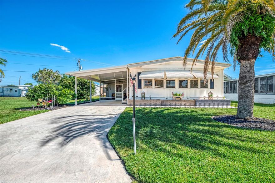 Harbor Isles Gem! Elegant 2-Bedroom Double Wide on Double Lot at Cul-de-Sac End! Tucked at the end of a peaceful cul-de-sac in the highly sought-after Harbor Isles gated community, this beautifully maintained 2-bedroom, 2-bath manufactured double-wide home is truly something special. Sitting on a rare double lot, this home gives you extra room to spread out, relax, and enjoy the Florida sunshine all year long. Step inside and you’ll instantly notice the bright, open layout offering a spacious 1,344 sq. ft. of living space. There’s a living room and family room with laminate flooring and custom Levlor blinds ($2400. value), spacious dining room offering built in hutch & updated light chandelier, giving you plenty of space to entertain, unwind, or simply enjoy the easy flow of this home. The kitchen is a true standout, featuring a Martha Stewart center island with pull-out drawers, a butcher block countertop, stainless appliances, decorative stainless backsplash and a breakfast bar—perfect for morning coffee or casual meals. There’s ample cabinet and counter space, plus a 2-year-old stove and dishwasher that have barely been used. New waterproof vinyl flooring adds style and durability in the kitchen and dining areas. Both bedrooms are partially furnished and generously sized, offering plenty of comfort and added built-in storage. A new roof, new carport, and new screening were all added in 2023, giving you peace of mind and big value. Enjoy the screened carport area for morning breezes or relax in your private back patio, surrounded by white vinyl privacy fencing—a perfect spot to enjoy the outdoors. Outside, there’s also a storage shed/workshop complete with washer, dryer, and wet sink—ideal for hobbies or extra storage.  The front landscaping is inviting offering multi colored rock gardens, accent lighting, and an array of shrubbery and mature Palms. This home is located in Harbor Isles, a gated 55+ community packed with amenities including a heated pool, sauna, hot tub, fitness center, tennis, pickleball, shuffleboard, and more. The marina offers fishing, kayaking, and direct access to the Myakka River and Gulf. With low monthly fees of just $190, which include cable TV and internet, this home offers both comfort and incredible value. Just minutes from Wellen Park, beaches, shops, dining, and quick access to I-75—this is Florida living at its best! Don't miss your chance to own a slice of paradise—schedule your private tour today!