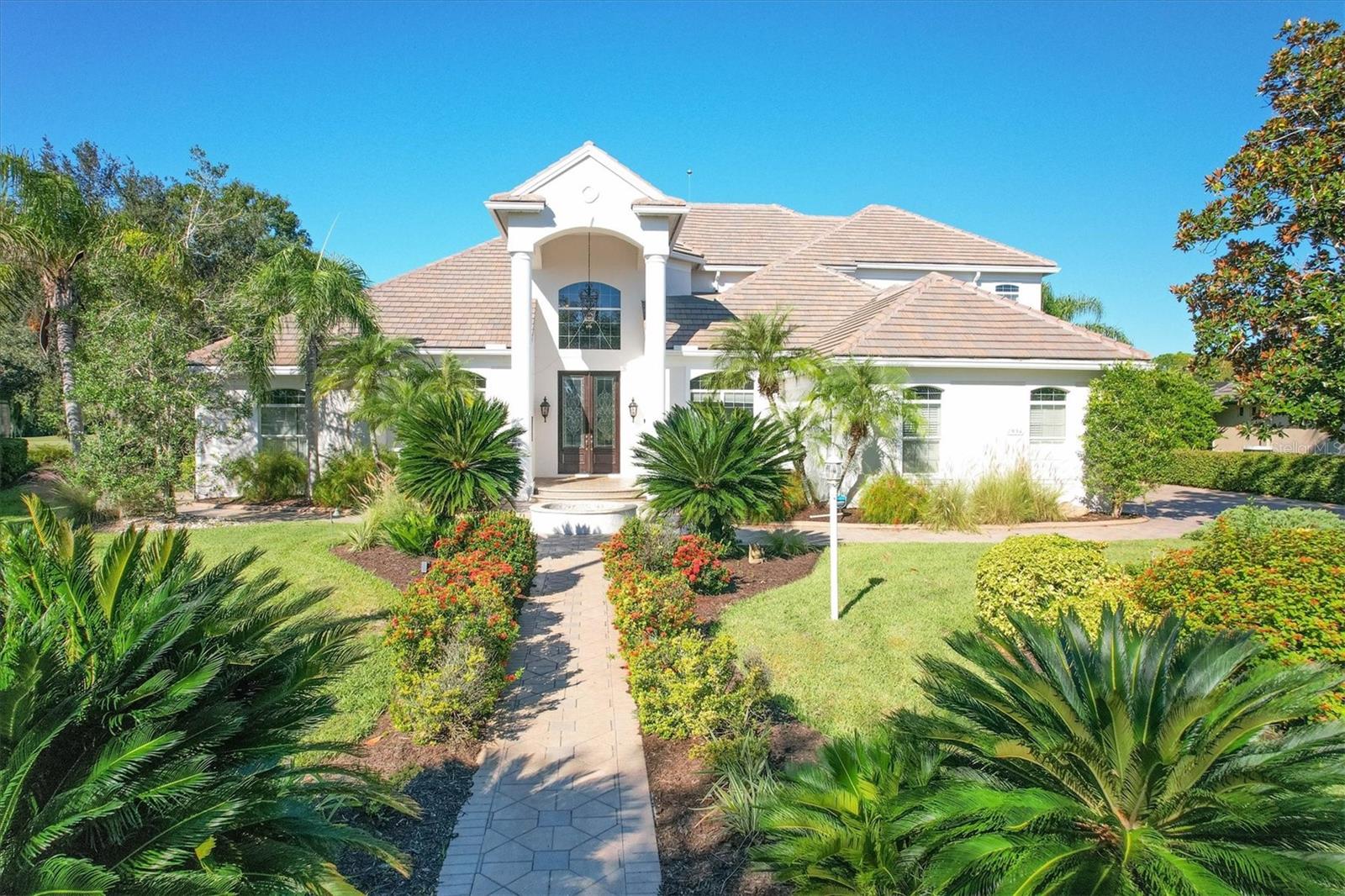 Welcome to your dream home in the esteemed Lakewood Ranch community. This stunning residence at 7954 Royal Birkdale Circle offers an unparalleled blend of luxury, comfort, and style. Nestled within the lush and meticulously landscaped grounds, this immaculate property is an oasis of tranquility and refined living.
As you approach this beautiful home, you'll be captivated by its elegant curb appeal. The Mediterranean-inspired architecture, with its tile roof and lush greenery, sets the stage for what lies within. This spacious 4-bedroom, 4-bathroom home including an office, theatre and bonus room exudes warmth and sophistication, featuring an open floor plan with an abundance of natural light, soaring ceilings, and designer finishes. In addition to the large 3 car garage there is also a 1 split golf cart garage, perfect for this golf community.
The heart of this home is the gourmet kitchen, which is a chef's delight, boasting granite countertops, stainless steel appliances, and a center island. Whether you're enjoying a casual meal in the breakfast nook or entertaining guests in the formal dining room, this home provides the perfect backdrop for all your culinary adventures.
The living room, with its cozy fireplace is an inviting space to unwind or host gatherings with friends and family. Large french doors lead to the screened lanai, where you can savor your morning coffee or evening cocktails while overlooking the tranquil water views and the lush landscaping that Florida is known for.
The master suite is a true sanctuary, offering a spacious bedroom, two walk-in closets, a His and Her's bathroom's, a soaking tub, and two walk-in showers.
Three additional well-appointed bedrooms ensure everyone has their own space, and there's even a home office, perfect for those who work remotely.
7954 Royal Birkdale Circle is situated in the heart of Lakewood Ranch, a master-planned community known for world-class golf, and a plethora of amenities. This home's location provides easy access to shopping, dining, and cultural events.
Don't miss the opportunity to make this your forever home. Schedule a private showing today and experience the epitome of Florida living at 7954 Royal Birkdale Circle.