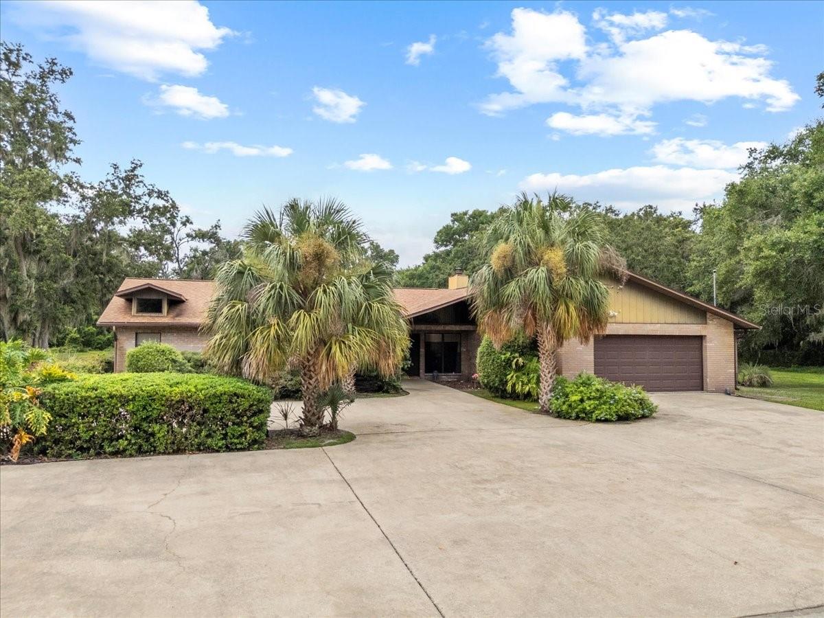 This tucked away property features privacy and seclusion right in the heart of Brandon. Non subdivision 3.3-acre parcel that offers a playground for owners of RV's, boats, and other hobbies and toys. A gated entrance off the public road leads you along a driveway to the home. There are 3 different garage/workshops to choose from. Custom built home features a unique, large in-ground pool that is located on the covered lanai with a 1/2-bathroom, wet bar and a wood- burning fireplace. Surrounding deck is non-slip river-rock. Glass doors along exterior of the lanai give an uninterrupted view of the rear yard. The main home features 5 bedrooms and 2.5 bathrooms. Prepare to be impressed when you enter the front door with a formal living room and dining room, plus a sunken conversation area that has a cozy seating area and fireplace. The kitchen has been upgraded and is adjacent to a breakfast nook. The family/recreation room has soaring ceilings and plenty of room for ping-pong, pool tables and other entertainment. On that side of the home are 2 more bedrooms with closets that are being used as an office and exercise room. Windows on the West side of home have 3M energy efficient film to save on electricity. Honeycomb shades in most of the home will stay. There is a 2-car garage off the family room. Long time owners have updated the spacious, primary suite and bathroom. You will enjoy the private access to the pool. 2 guest bedrooms with an upgraded bathroom are on that side of the home. Plus, a laundry room, that has spacious cabinets and extra space for crafting/sewing etc. Washer and dryer will stay. There are two large separate garages off the circular driveway. 1st building is 39x21 and features a 2-car garage, plus a workshop with a 15ft. roll-up door. It has a bathroom and a finished room that can be used for storage or converted into a small apartment. There is an adjacent RV carport beside this building. A newer, separate 4 car-garage adds more space for owners with multiple cars. The owners had poultry and there is a small enclosure that can easily be made ready for chickens or other pets. Property is zoned RSC-2. House has 4,224 sq. ft. of living area. There is room to roam here and add on to as needed. Bring your horse if you have one. Shopping, good schools and quick access to I75, Selmon Expressway, Gulf beaches and downtown Tampa make living here very special. Hurry today and see for yourself how you can enjoy the best of Florida in your own private oasis.
