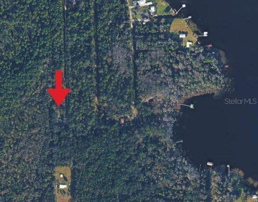 Peaceful building lot near George’s Lake in Florahome.
Enjoy the tranquility of lake living just a hop, skip, and a jump away — only one block from the water, with a short ride to the public boat ramp. The protected land behind the property adds a sense of privacy and natural surroundings, ideal for those seeking quiet outdoor living.

Located in Putnam County, approximately 50 miles south of Jacksonville, this very up-and-coming area is becoming increasingly desirable for buyers who value space, nature, and recreation. The area is a hidden gem for outdoor enthusiasts, offering excellent fishing, boating, kayaking, and water sports on nearby lakes and rivers. Several hunting preserves are close by, including portions of the Ocala National Forest, and the Florida Trail runs through the heart of the county, providing scenic hiking and wildlife viewing.

Whether you’re looking to build a peaceful full-time residence, a weekend getaway, or a smart investment property, this lot offers the flexibility to design your own home and outdoor space to match your lifestyle. If you’re drawn to privacy, nature, and outdoor recreation in a growing area, this is an opportunity you won’t want to miss.
