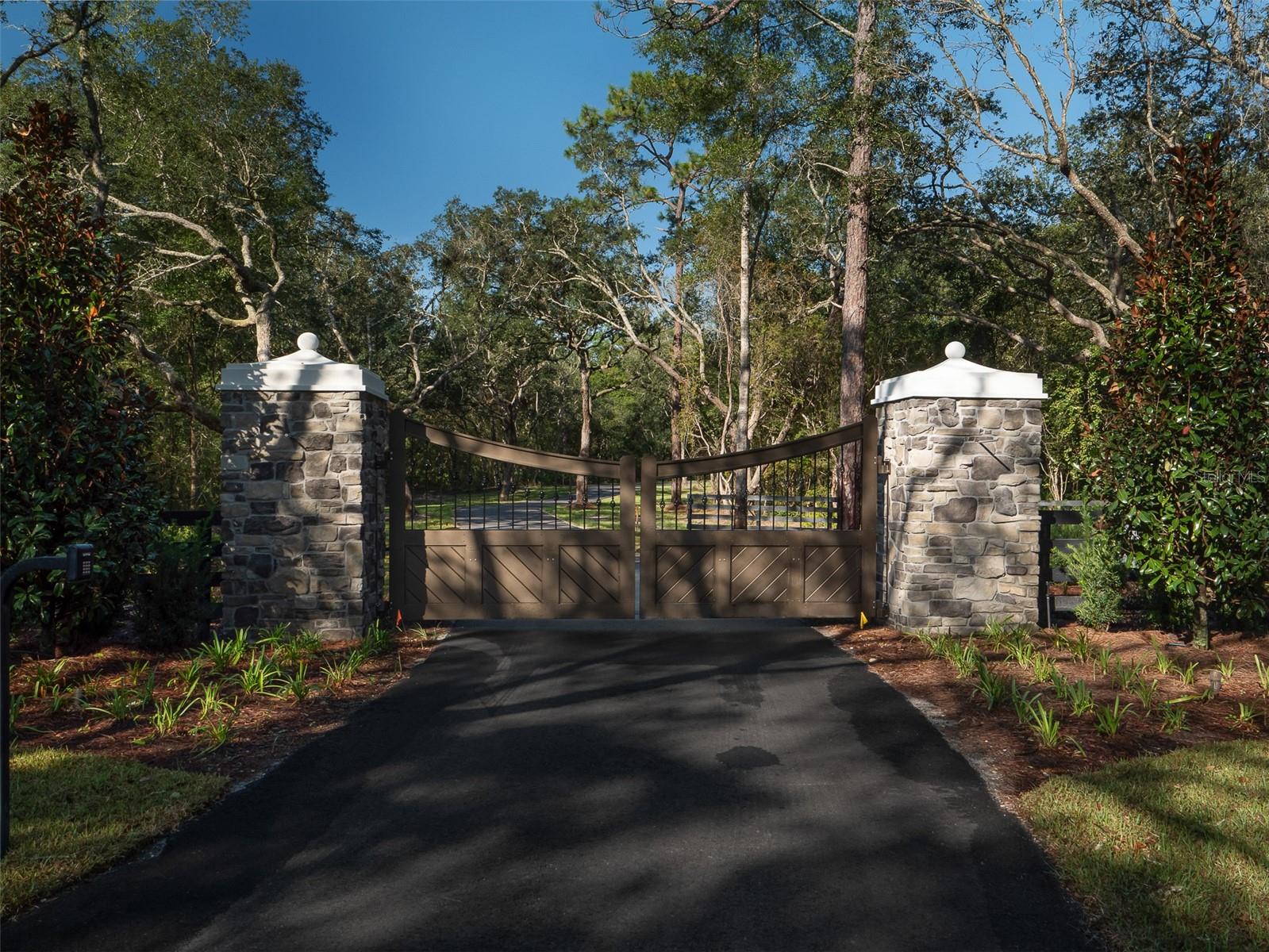 10 minutes to the World Equestrian Center! With approximately 36 acres of cleared land, you've got a blank canvas on which to design and build your paddocks, barns, arena, storage, and of course, the custom home that so far you've only envisioned. Think of yourself being smackdab in the middle of Ocala's horse country, surrounded by like-minded horse enthusiasts! This property has been improved with perimeter fencing, as well as a stunning gated entrance that will welcome you and your horses home, and impress your friends and family! Past the gate, lined with mature trees, the paved winding driveway offers a serene and picturesque approach to your future home, making every arrival feel special. The driveway not only enhances the property's beauty but also provides a sense of seclusion and tranquility that's hard to find elsewhere. Come take a look for yourself, and picture yourself on your new farm! If you would like a jumpstart on designing and building your farm, several home and barn plans are available, as well as recommendations for first-rate contractors that build homes and barns in a seamless, proficient, and professional manner.