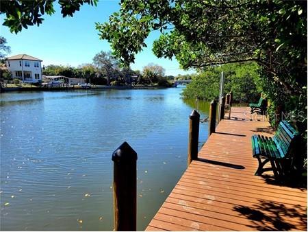 Turnkey water view condo in desirable Sarasota available May-October 2025. This immaculate 2 bedroom 2 1/2 bath condo features an open floor plan, fireplace, beautiful wood floors throughout, washer and dryer in unit. Sit on your screened lanai and enjoy your coffee before setting out to all Sarasota has to offer! Central Park II is centrally located to downtown shopping and restaurants and the wonderful Bayfront Park. The community offers a fishing pier, heated swimming pool, BBQ, tennis and pickleball, fitness, library, bike racks, a private dock on Hudson Bayou with a kayak launch and much more! Publix supermarket and bus stop right across the street. Only a half mile from Sarasota Memorial Hospital.