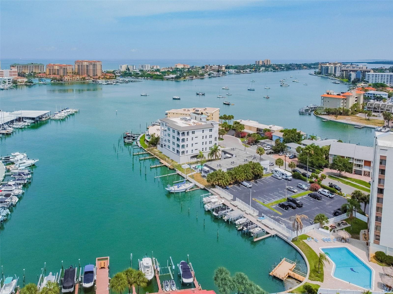 FULLY FURNISHED CLEARWATER BEACH CONDO JUST MINUTES FROM THE WHITE SAND IN CLEARWATER BEACH. This unit has just been updated with a NEW Stainless Steel Refrigerator, New Stainless Dishwasher, New Bedding, Pillows, Dishes and cookware. Just 1 minute to Publix nearby restaurants and more. The white sandy beaches are just 1 mile over the bridge. Don't feel like strolling down to the beach? Take the Jolly Tolley, or free rides all the over Clearwater Beach Community. This short term rental is available for 3 months (minimum) or more and require HOA approval. Owner will do a long term lease but prefers a short term. Condo rented fully furnished, owner will not remove the furnishing for a lease. Located on Island Estates of Clearwater Beach, Island Estates is a residential neighborhood just before the island of Clearwater Beach and the famous Pier 60. It's a 2 minute drive to the Gulf of Mexico, or 1.5 miles to Pier 60 and the white sandy Clearwater Beach, continually voted the best of America’s Top Beaches! This fully furnished unit has an open floor-plan loft style efficiency with built in murphy bed for sleeping but out of the way during the day. You will enjoy watching dolphins play in the bay, birds singing, and fabulous weather year round. Amazing views of the intracoastal and downtown Clearwater skyline. Clearwater Marine Aquarium is right across the street. The newly updated Publix is down the street 2/10ths of mile. Unit includes cable, internet, water, sewer, trash and electricity. Dolphin Cove condominiums offer a quiet place to retreat and relax away from the cold winters. Oversized open pool with picnic areas and tiki huts, BBQ area, fishing dock, restroom facilities equipped with outdoor showers. Community features include recreation room with lots of space, and internet, mini library, games, and a large kitchen, additional features include onsite laundry, trash chutes for easy disposal, 24 hour locked entry and cameras offer a secure place to live. Clearwater is known for some of the best beaches, restaurants, and outdoor activities. Nearby banks, shopping, medical facilities, art museums, and loads of outdoor activities, biking, paddle boarding, and more all nearby. Jolly trolly and Free rides run through the area regularly so you don't need your car. Very nearby to Caladesi Island State Park, and Honeymoon Island are places you don’t want to miss.