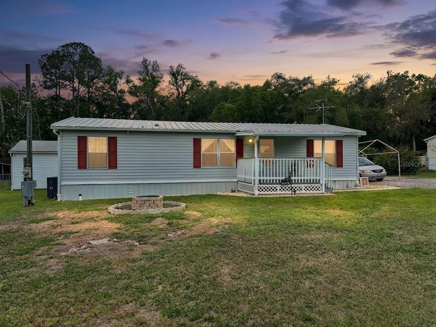 Updated 3 Bedroom Mobile Home on .70 Acres in Ocklawaha – Garage, Pool, She Shed & More!

Welcome to this well-maintained 3 bedroom, 2 bathroom mobile home in Ocklawaha, Florida, situated on a spacious 0.70-acre lot with a blend of comfort, functionality, and outdoor living.

This home features a metal roof with gutters, vinyl siding, and aluminum skirting, offering durability and low maintenance. Enjoy relaxing mornings or evenings on the covered front porch with wood decking and lattice detail, perfect for enjoying the Florida lifestyle.

Inside, you’ll find luxury vinyl plank flooring throughout the main living areas and bedrooms, providing a clean, modern feel. The kitchen is equipped with Formica countertops, electric stove, microwave, dishwasher, and refrigerator, making it move-in ready. Ceiling fans in the living room and primary bedroom add comfort and efficiency.

The primary suite includes a walk-in closet located within the bathroom and a convenient in-bath laundry area, maximizing space and functionality.

Step outside and you’ll find everything you need:
Above-ground pool for cooling off on warm Florida days
She shed – perfect for hobbies, workspace, or storage
Two-car detached garage with enclosed lean-to for additional covered space
Asphalt millings driveway for easy access and parking
Fenced dog run area for pets
Well and septic system – no HOA and added independence

The property also features a large HVAC system in good condition, giving peace of mind for year-round comfort.

Located in Ocklawaha, this home offers a quiet setting while still being within reach of Ocala, The Villages, and nearby lakes, trails, and outdoor recreation.

If you're looking for space, versatility, and value in Central Florida, this property checks all the boxes.

Schedule your showing today and come see everything this property has to give!