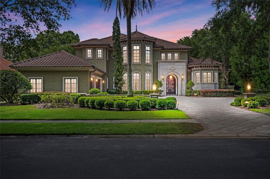 Enter into the realm of enchantment with this breathtaking Tuscan-style estate nestled in the prestigious Lake Butler Sound community. From the moment you step foot inside, prepare to be captivated by the sheer architectural beauty and refined elegance that surrounds you. The grand salon, adorned with soaring 30-foot ceilings, beckons you with its magnificence, while a circular staircase invites you to explore further.

As you wander through the home, you'll find yourself mesmerized by the stone fireplace, its warm glow reflecting off the crystal-clear waters of the spectacular pool, complete with a cascading waterfall and inviting spa. Archways and columns gracefully define the grand salon and dining room, leading you to an extraordinary gourmet kitchen. Here, an oversized island takes center stage, complemented by custom wood cabinetry and a walk-in pantry that will delight even the most discerning chef.

Open the doors from the family room, and a well-equipped summer kitchen awaits you, beckoning you to embrace the joys of outdoor living. Complete with a fireplace and expansive outdoor space, it sets the stage for unforgettable gatherings and celebrations, where cherished memories will be made.

Retreating to the master suite on the first floor, you'll discover a sanctuary that provides a tranquil escape. From its vantage point, you'll be treated to stunning views of the pool and lush landscape. Indulge in the opulence of the exquisite bathroom, boasting a jetted tub, a luxurious shower, double sinks, and custom-built closets that cater to your every need.

An office/guest bedroom and a powder room also grace the first floor, offering convenience and versatility. Ascend to the second floor, and you'll find three additional suites, each with its own unique charm, along with another thoughtfully placed powder room. A spacious loft overlooking the grand salon invites you to pause and take in the beauty that surrounds you.

Winner of the esteemed "2003 Street of Dreams Showcase," this extraordinary estate is a testament to meticulous craftsmanship and attention to detail. Every element, from the rich wood floors to the artful stonework throughout, has been carefully selected to create an ambiance of timeless elegance. State-of-the-art fixtures and Tuscan-inspired paintings add the finishing touches, culminating in a residence that exudes sophistication and grace.

Prepare to be enchanted as you step into this magnificent home, where architectural splendor and refined luxury combine to create an unparalleled living experience. Welcome to the epitome of exclusive living in Windermere's most sought-after community.