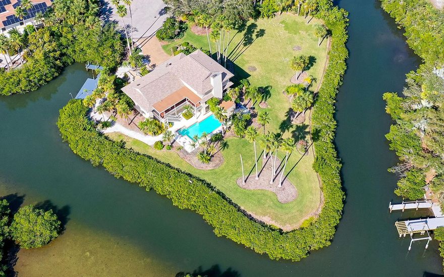 1+ acre waterfront property surrounded by 370 feet of water on three sides. This listing includes two parcels: 1) .68 acre with the existing home, and 2) .44 acre buildable lot that can be developed with a large waterfront home on a deep canal. Serene privacy on a cul-de-sac in the secluded South Creek community directly across from Oscar Scherer State Park and just 5 minutes to Pine View School for the Gifted. Located between Sarasota and Venice with easy access to the best amenities in both communities including beaches, shopping, dining, arts, medical and personal services. Private dock for two boats, along with kayak/paddleboard launch, provides easy access to Sarasota’s coastal waterways for endless days enjoying Florida’s year-round sun and fun. The 5,233-square-foot residence has five bedrooms, five baths, plus an in-law studio apartment. All levels feature expansive outdoor lanais/balconies with water views. Living areas are on the second level and include formal living room with cathedral ceiling, formal dining room and family room with wood-burning fireplace. The third level has the owner's retreat featuring sitting room, dual bathrooms, 24x16 bedroom and balcony with the best views of the house. This residence is on the same street as South Creek community amenities which include tennis courts, playground, day dock and night security gate. The singular combination of location, waterfront and size make this a remarkable property for an exceptional lifestyle.