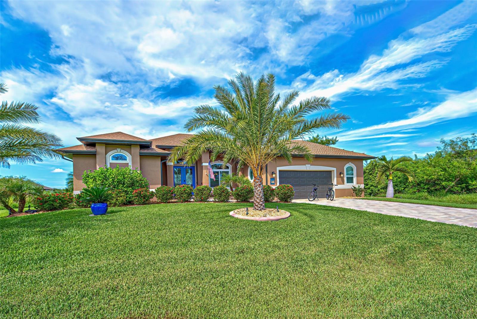 Move-in ready - Solar powered Home designed for effortless Florida living! This gorgeous WATERFRONT home is offered TURNKEY furnished. Located in the heart of South Gulf Cove in Section 93, with a SEA WALL, boatdock and lift, this location is prime! With just minutes away from the Interceptor Lagoon, Charlotte Harbor, the Gulf and beyond! This HOME is loaded with upgrades like: New Roof, Hurricane Impact Windows and Sliders, Cat. 5 Keflar screens for lanai, Photo Voltaic Solar System, new wrap around boatdock, new St. Augustine sod – look for attached upgrades list. Simply stunning 3BR / 2BA / 2 Car plus workshop/storage.
Beautiful curb appeal with the etched double doors where an elegant greatroom will draw your eyes to volume tray ceilings with rope lighted crown, before feasting on the waterway views in your very own back yard. Between the sizable great room and adjoining formal dining room, indoor entertaining will be a pleasure. The gourmet kitchen features granite countertops, crowned cabinets, new appliances and a lovely stone backsplash. This adjoins a dinette with phenomenal aquarium windows overlooking the pool and outdoors and adding to the feel of natural light and spaciousness of this home. The master bedroom in this split plan is large enough to include a reading alcove and an admirable window pattern over the bed! The EnSuite is tastefully enhanced with a step-up garden tub garden with tile surround, as well as a separate walk-in shower. Double vanities, an eyebrow window, and plant shelves are touches not always found in today’s master baths. One of the guest bedrooms in this split plan has French doors opening to the lanai, and the other guest bedroom has a large walk-in closet. Both are generously sized for the comfort of your guests and family. Ready to go outside? The ultra large pooldeck has a large, covered area for dining or lounging and enjoying the waterfront views! There are remote controlled pool cage lights and Keflar Shutter for the lanai. The sparkling saltwater pool comes with a new pool heater for cooler days. Walk down to your concrete dock framed with a new wood wrap around dock and canopy frame with new tarp to protect your boat. New boat lift motors w/remote. Inside Laundry Room, Canal supplied irrigation system, landscaping lighting.Average power bill $70/mth.