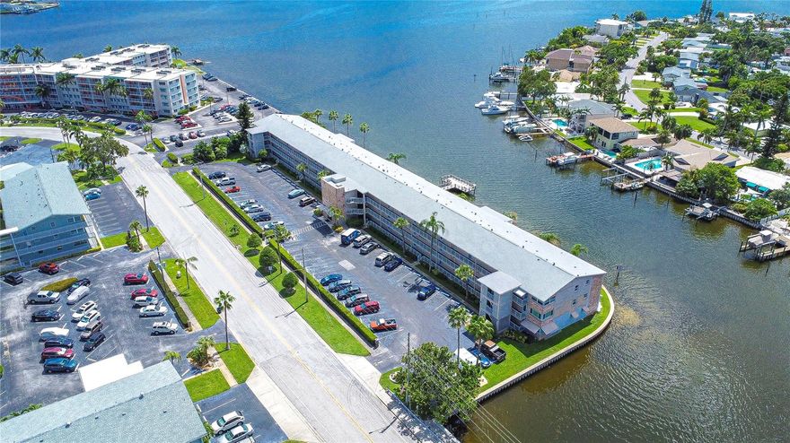 Experience the ultimate waterfront lifestyle in this beautiful condo, where every day begins with breathtaking views of Boca Ciega Bay and the Intracoastal Waterway. Imagine sipping your morning coffee while watching dolphins, manatees, and passing boats from your expansive Florida room. Nestled within the serene 55+ Shore Plaza community, this charming residence is just minutes from the award-winning St. Pete Beach and is brimming with amenities to enhance your comfort and enjoyment.  This inviting condo features two generously sized bedrooms, a full bathroom, and a spacious Florida sunroom that offers versatile space—perfect as an office, guest room, or relaxing lounge. This condo features dual entry doors, the front entry from the living room and another from the bedroom.  Upon entering the front door, you'll be greeted by a warm and welcoming living room, seamlessly connected to a fully equipped kitchen with a gas stove, ample cabinet storage, and a large sink. The sunroom is an ideal spot to unwind, whether you're starting your day or winding down with evening cocktails. There is a laundry room located on every floor along with a trash shoot.  Shore Plaza offers a host of amenities, including a scenic dock and fishing pier, waterfront picnic tables with a gas grill.   The condo fee covers cable/internet, gas, water, and building maintenance, with a central gas boiler that helps reduce individual insurance costs. You will love the Shore community with its clubhouse, heated waterfront pool, fitness center, billiards, and a kitchen.  Conveniently located in South Pasadena, you'll have easy access to shopping, dining, and medical facilities, as well as the new SunRunner Express bus that can whisk you away to the beach or downtown St. Petersburg. Explore the vibrant cultural scene, trendy restaurants, and world-class museums of downtown St. Petersburg and Gulfport, all just a short drive away. Plus, Tampa International Airport is only 35 minutes from your door.