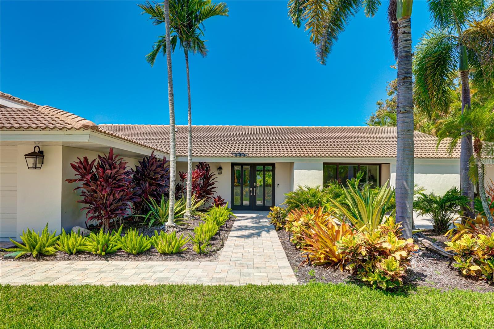 Beautifully updated 3-bedroom, 2.5-bathroom pool home, situated in the sought-after island community of Bird Key. The vibrant tropical landscaping beckons as you approach, offering a glimpse of the beauty that awaits within. From the moment you open the front door, your eyes will be captivated by the panoramic view of the private, fully fenced backyard, visible through the expansive wall-to-wall impact resistant sliding glass doors. The outdoor space is a true oasis, boasting a large patio and a sparkling pool and spa with a sun shelf, PebbleTec finish, and impeccable tile work. It's the perfect place to unwind and create lasting memories. Indoors, you'll be enamored by the open floor plan. An electric fireplace, adorned with charming masonry stone, is featured in the living room that then leads seamlessly to a formal dining area. The kitchen is a culinary dream, featuring an oversized island with bar seating, sleek quartz countertops, and modern stainless steel appliances. The primary suite is a luxurious retreat, complete with an ensuite that includes dual vanities, a freestanding soaker tub, and a rejuvenating walk-in shower equipped with dual rain shower heads and invigorating body jets. One of the two secondary bedrooms boasts an ensuite bathroom and walk-in closet, while the third bedroom provides access to a charming covered patio at the front of the home. The home has impact resistant windows and sliders throughout, updated plumbing & electric and a new AC system. Bird Key's strategic location provides easy access to the vibrant cultural scene of downtown Sarasota, just a short drive away. Explore art galleries, theaters, boutique shops, and a diverse range of dining options. For beach lovers and outdoor enthusiasts, neighboring Lido Key offers beautiful beaches and recreational activities. Additionally, residents enjoy the nearby St. Armands Circle, renowned for upscale shopping, dining, and entertainment options. With its central location in Sarasota, Bird Key ensures convenient access to parks, golf courses, marinas, and other attractions, making it the ideal place for those who seek an active and engaging lifestyle. Don't miss the opportunity to make this exceptional property your new home. Explore it today and experience the epitome of Sarasota living.