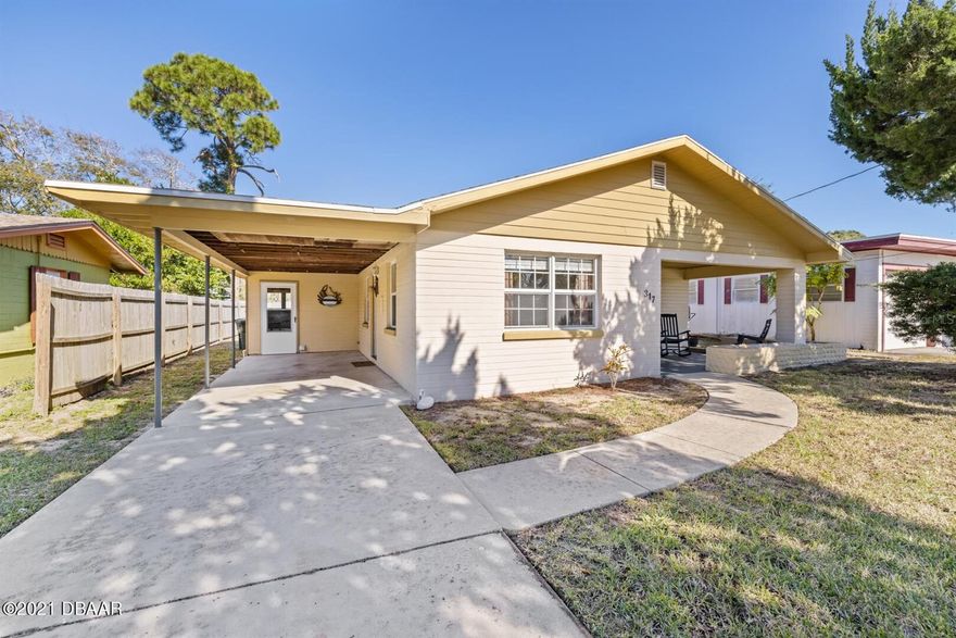 Adorable beachside bungalow just a short stroll to the sand, where coastal living and convenience come together. This charming home features laminate flooring throughout the main living areas, with tile in the kitchen and bathroom. Updated windows (2014) fill the home with natural light. The kitchen opens to a large, fully fenced backyard—ideal for outdoor entertaining after a day at the beach, perfect for pets, or creating your own tropical retreat. A utility room at the rear of the carport houses the washer and dryer and offers additional storage space. Recent improvements include a newer well and sprinkler system, making it easy to maintain vibrant landscaping year-round. Located in a desirable coastal area close to popular beach attractions, waterfront dining, shopping, and local entertainment, this home offers the perfect balance of relaxation and activity. Whether you're looking for a first home, retirement escape, or vacation getaway, this coastal retreat delivers.