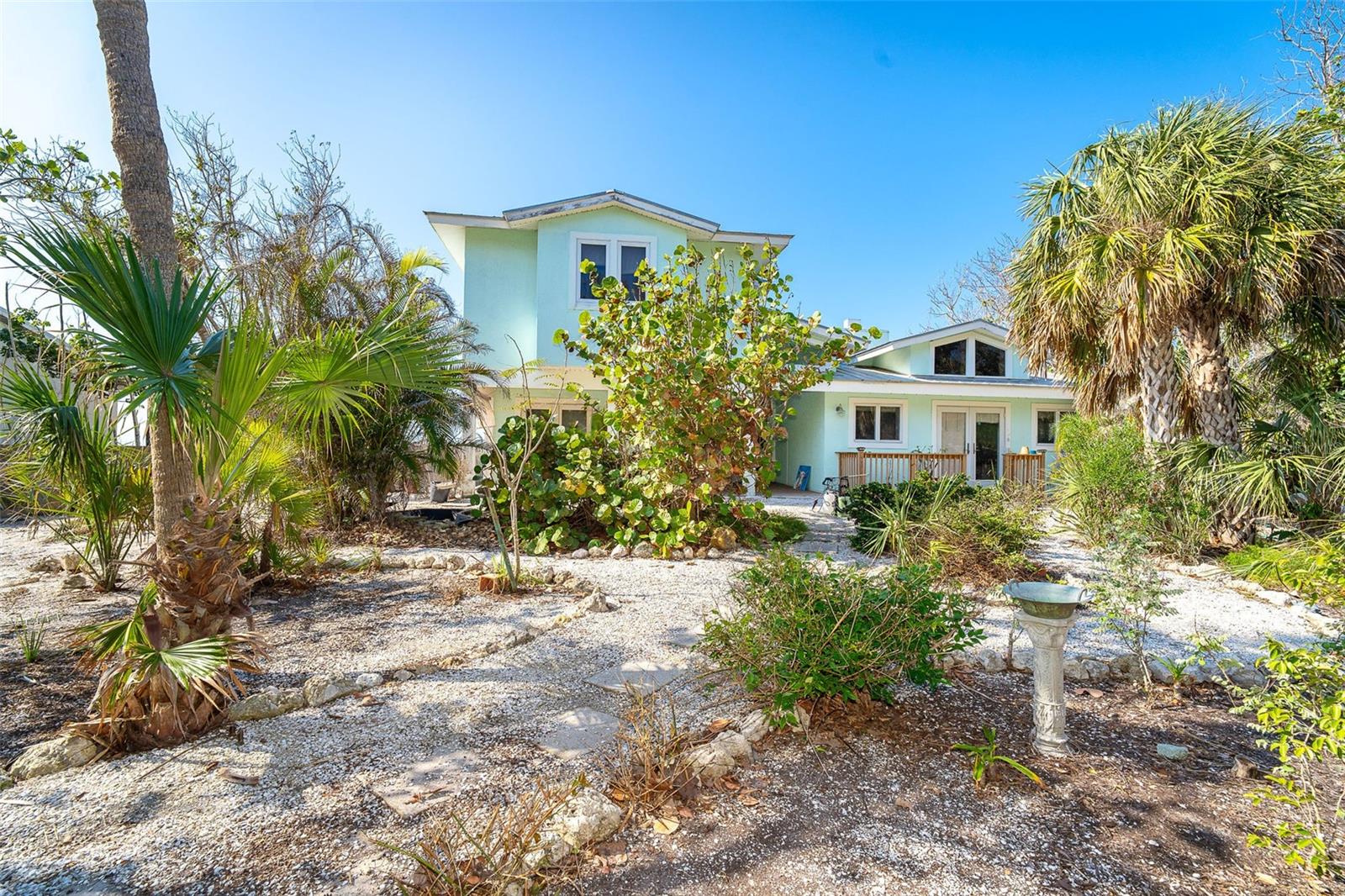 Property is being sold "AS IS" Damage due to the recent hurricane creates a unique opportunity to build new or renovate the current home. This two story home has three bedrooms, 2 1/2 baths and features a detached workshop and Guest Studio. The lower level has been professionally remediated following the recent hurricane. Fireplace and upper-level cabinets remain intact.
This amazing property has captivating view of the Gulf of Mexico and can be restored to its original beauty or tear down and Build New! This property provides the perfect canvas for your aspirations, the natural beauty and foliage provide the tranquil atmosphere of this coastal gem. The possibilities are endless whether dreaming of a coastal masterpiece or charming beach cottage.
