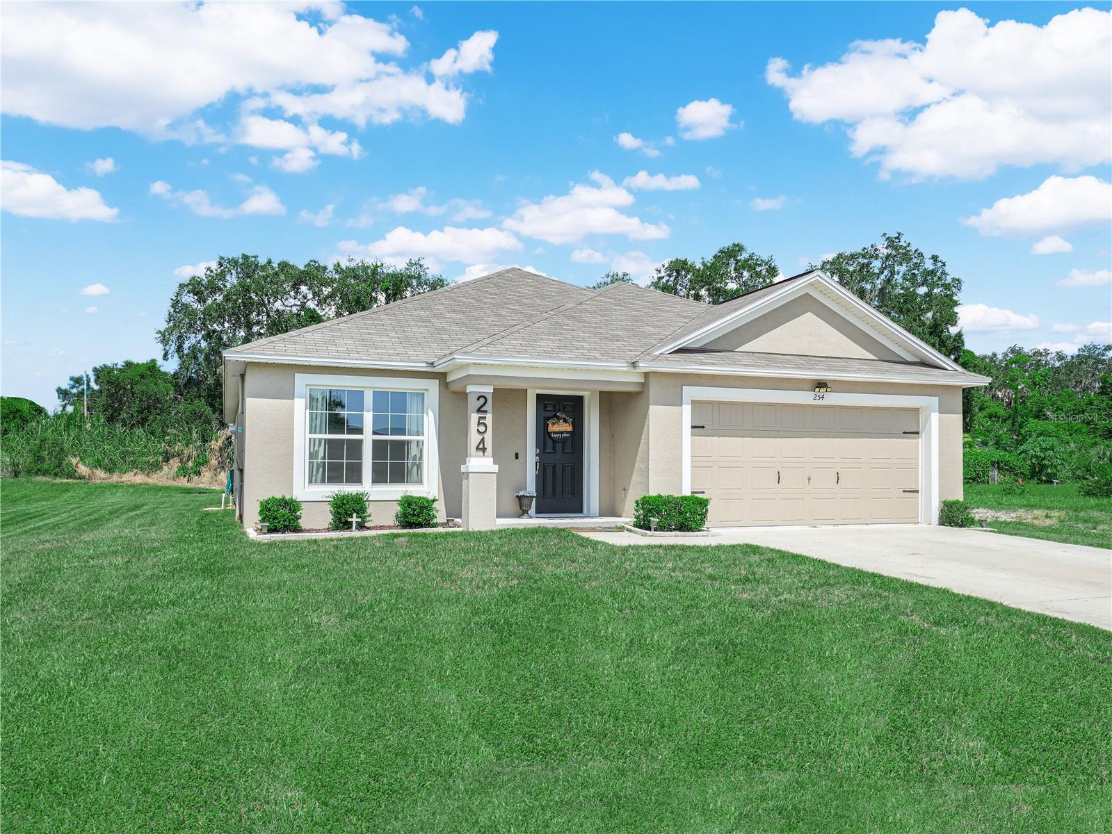 Welcome to this beautifully maintained 4-bedroom, 2-bathroom home, built in 2023 and located just minutes from downtown Frostproof. With no HOA, this property offers freedom and convenience. Enter through a welcoming and convenient entryway that leads into a bright dinning room. The dining area is generously sized, ideal for hosting family dinners. The kitchen features epoxy countertops, a large island with bar-top seating, stainless steel appliances, and a dedicated laundry room conveniently located just off the kitchen. The living room and kitchen flow seamlessly. Creating a great room, welcoming and perfect for entertaining. The large master bedroom is spacious, complete with dual vanities in the master bath, a spacious walk-in closet. Additional highlights include a 2-car garage, large driveway, and full irrigation system. Every detail of this home reflects care and quality—move-in ready and built to impress. This home was loved and ready for its new owners!