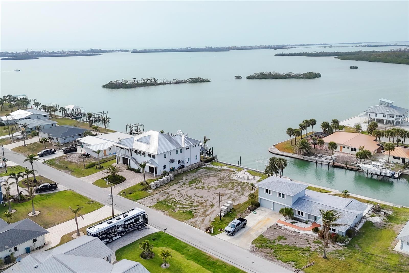 This vacant lot offers stunning Sunset views over the tranquil waters of Lemon Bay, providing the ideal setting for your dream home. Surrounded by diverse wildlife, including manatees, dolphins, and scores of birds with a rookery off in the distance. You will find plenty to admire. This property provides easy access to the Gulf of America with no bridges which makes it perfect for the boating and fishing enthusiast. With a private boat lift, you’ll have quick and easy access to some of the best beaches and fishing spots in the area where tarpon, snook, trout and redfish are abundant. Don’t miss your opportunity to build your dream home in Paradise!