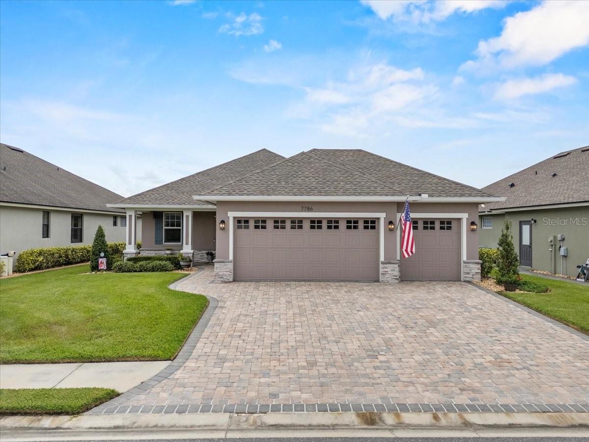 Built in 2021 by Ernie White Construction, this stunning home is packed with upgrades and thoughtful details throughout. From the rich wood flooring and custom fireplace, to plantation shutters, remote-control shades, custom primary closet, and an awning that extends your patio shade, no detail has been overlooked. This popular floor plan features 3 bedrooms and 2 bathrooms, though the versatile front room is often enjoyed as a home office, craft space, or cozy den it is considered a 3rd bedroom in public record. The heart of this home is the stunning kitchen, designed to impress and function beautifully. It overlooks the living room, dining room and provides seamless views of the oversized lanai, creating the perfect space for entertaining or relaxing. The kitchen is complete with a custom glass pantry door, crisp white cabinetry, granite countertops, and stainless steel appliances.The private primary suite is tucked toward the back of the home and offers plenty of room! The ensuite features dual sinks, a large walk-in shower, and a custom walk-in closet. The additional bedroom is located at the front of the home with convenient access to the guest bath, making it an ideal setup for visitors. A generous laundry room provides added functionality and leads directly to the spacious 3-car garage. With room for two vehicles and a golf cart, you will have plenty of space for storage and convenience. Last but surely not least you have not only the oversized screened in lanai as mentioned with a fixed awning for additional shade as well as an additional paver non screened extension perfect for setting up your grill or fire pit! Lake James is a maintenance free living community! So your landscaping and lawn care are included in your HOA fee as well as your cable/internet! This community is very active and has something to offer everyone! As mentioned it is Golf Cart friendly so you are able to ride down to the pool or just cruise the neighborhood! This community is Located conveniently to grocery stores, dining, and shopping. If you've been looking for a low maintenance lifestyle here is your chance!