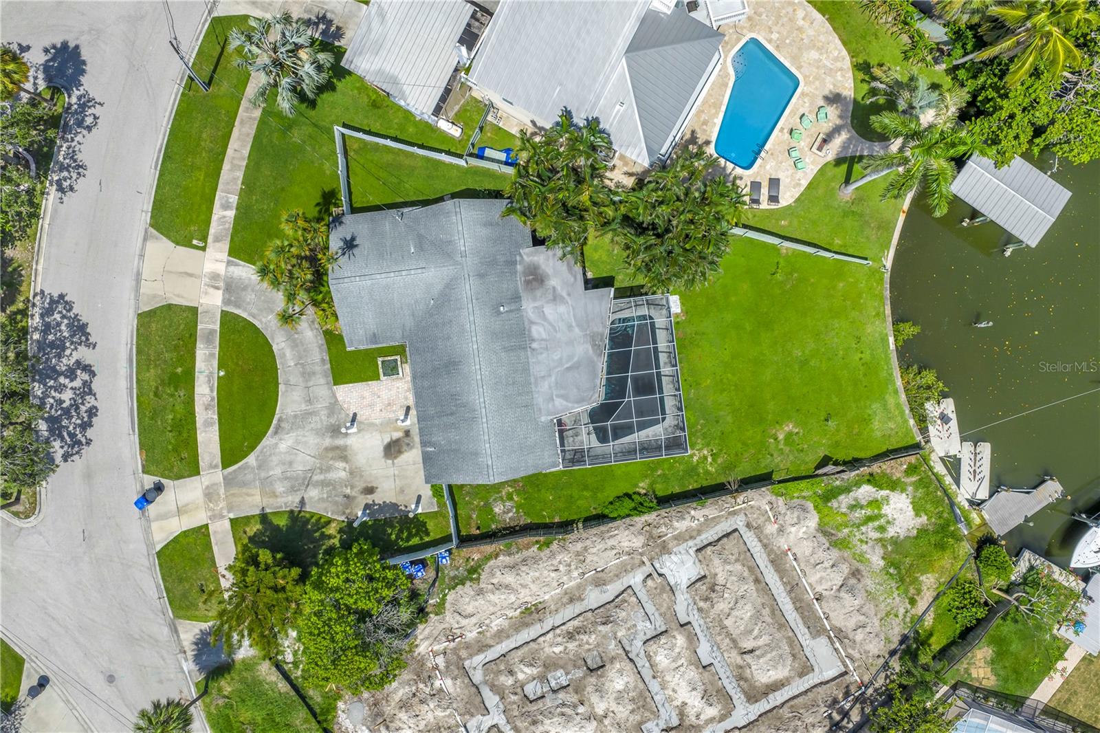 One or more photo(s) has been virtually staged. Waterfront Opportunity – Renovate or Build New in Northeast St. Pete
Located in the highly desirable Arrowhead Estates neighborhood, this 3-bedroom, 2-bath, 1,706 square foot block home sits on a generous waterfront lot with direct canal access to Tampa Bay and no fixed bridges—perfect for boaters and water lovers alike. The property sustained storm surge damage during the 2024 hurricane season and is being sold AS IS. Interior walls remain intact, offering buyers a chance to assess the existing layout before deciding whether to renovate or tear down and build new. A screened-in inground pool adds significant value and could easily be incorporated into a new design or restoration plan. With ample lot space, there is room to add a 2- or possibly even a 3-car garage—an uncommon feature in this neighborhood. Surrounded by million-dollar homes on a peaceful street, this property is an exceptional opportunity to create a custom coastal retreat with potential for a dock, boat lift, and expansive outdoor living. The location provides the perfect balance of serenity and convenience, just minutes from downtown St. Petersburg, Shore Acres Recreation Center, waterfront parks, shopping, and dining. Buyers are encouraged to perform their own due diligence with the City of St. Petersburg and FEMA regarding renovation or new construction guidelines. The seller makes no guarantees about the current structure or future use. Whether you're seeking to renovate, rebuild, or invest, this property offers outstanding potential and long-term value in one of St. Pete’s most sought-after waterfront communities. This is your chance to build the ultimate waterfront lifestyle in one of Florida’s favorite communities, Arrowhead Estates. Don’t let this investment slip away—paradise is calling!