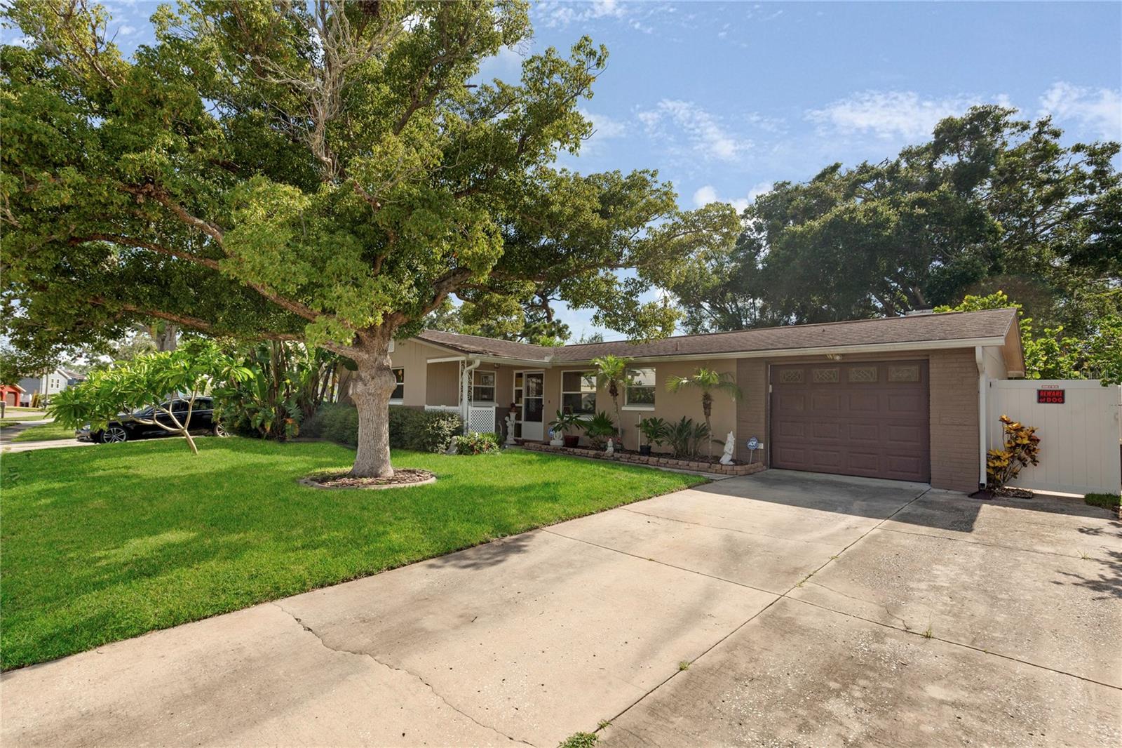Welcome to this spacious Pool Home on a quite Holiday street. This two bedroom layout is very comfortable and flows nicely. The updated kitchen offers Wood Cabinets & Granite countertops with newer appliances. The Family Room and Dining from flow together and pour into an expansive bonus room with wood burning fireplace. This would be a great secondary Family room, Gameroom with space for a pool table, Office or Fitness space. Tons of options!! Outdoor is the screened Pool deck with Summer Kitchen and full Bathroom. Great for entertaining. The pool is heated by solar which is great for your Snowbird friends visiting in the Winter. The home is conveniently located with all the amemenities you need. Come take your private tour TODAY!