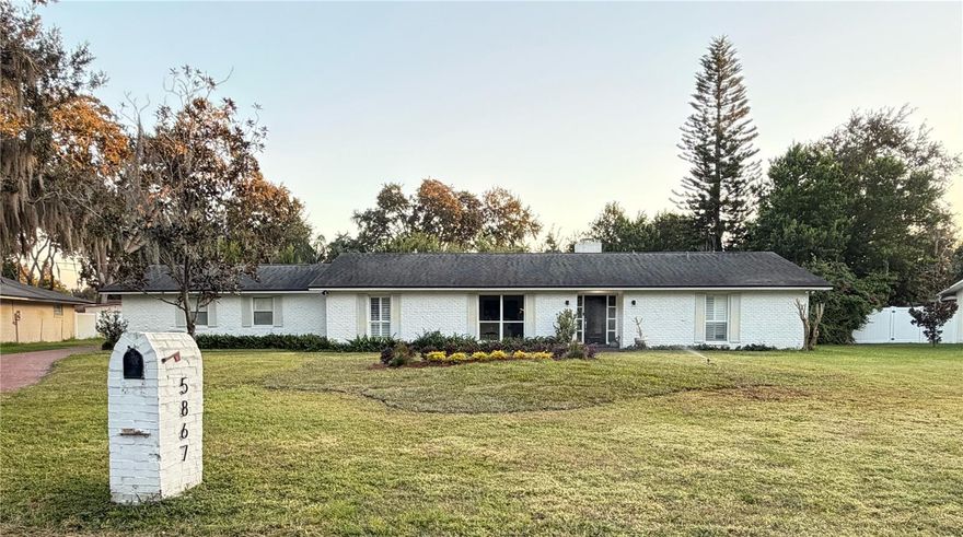 Located just 5 lots away from the neighborhood private lake access to the Conway Chain of Lakes. Discover a rare gem in Belle Isle’s coveted “Old Cove” section of Lake Conway East- where stately heritage homes sit majestically on oversized lots beneath towering ancient oaks. This is not your typical ranch home. This is a meticulously crafted custom residence that exemplifies the elegance and quality of one of Lake Conway’s most distinguished neighborhoods. Nestled on a premier lot, this property offers the privacy and grandeur that discerning buyers seek. Mature oak canopy and established landscaping create a park-like setting, while strategic rear plantings ensure complete privacy - your own private sanctuary just minutes from downtown Orlando, Orlando International Airport, and the area’s thriving medical complexes. Step inside to discover expansive rooms that immediately distinguish this home from ordinary ranch properties. Custom millwork reflects the craftsmanship of a bygone era, while oversized windows flood every space with natural light, creating an airy, sophistication. The heart of this home features a thoughtfully designed kitchen with extensive built-in storage and pantry space, along with chef-friendly open shelving that provides easy access as well as display space to incorporate the rest of the home’s design into its function. Adjacent, you’ll find a large, highly functional laundry room that doubles as a service hub with both cedar storage closet and catering pantry - perfect for effortless entertaining. The formal dining room provides elegant space for gatherings, while multiple living areas offer flexibility for both intimate moments and grand celebrations. New flooring throughout showcases meticulous attention to detail, while the primary suite features stunning hand-laid parquet floors reminiscent of French châteaux - a testament to the home’s custom nature and superior craftsmanship. Recent improvements include a newer roof for peace of mind, professional interior and exterior paint by a luxury home specialist, both bathrooms beautifully updated with modern materials and design, an expanded covered porch and deck area creating seamless indoor-outdoor living, a newer water heater installed in recent years, connection to city water from well, repairs to the operational irrigation system, the pool enclosure has just been freshly re-screened for optimal enjoyment, all new plumbing fixtures throughout the home, and a regular maintenance schedule for all mechanics, as expected. The crown jewel is the spectacular pool and entertainment area - a true tropical sanctuary featuring: deep swimming pool beloved by children and adults alike, expansive covered porch with custom tile floor-perfect for dining and relaxation, integrated BBQ and deck area for outdoor entertaining, complete privacy with mature landscape screening, and multiple seating and dining zones for various occasions. This is more than a home - it’s a lifestyle. The photos simply cannot capture the scale, quality, and sophisticated details that set this property apart. Schedule your private showing to experience the true grandeur of this Lake Conway heritage estate.