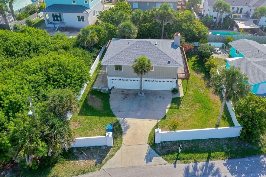 LOCATION!!! Lots of potential for this house east of A1A; a rare find for this location under $500k.  Big lot and fenced yard with gate for privacy.  Roof done in 2017; NEW AC in 2022; home remodeled in 2017. Open floor plan with fireplace in living room. Huge 4 car garage and laundry room on ground floor, with room for more parking outside garage. House has many options, and room for expansion; so many possibilities. Enjoy the ocean breezes so close to the no-drive beach. Beautiful tropical bougainvillea off the 2nd story wrap around deck. Great vacation home or full time residence. 
Measurements deemed to be accurate but to be verified by buyer. ;Water: City