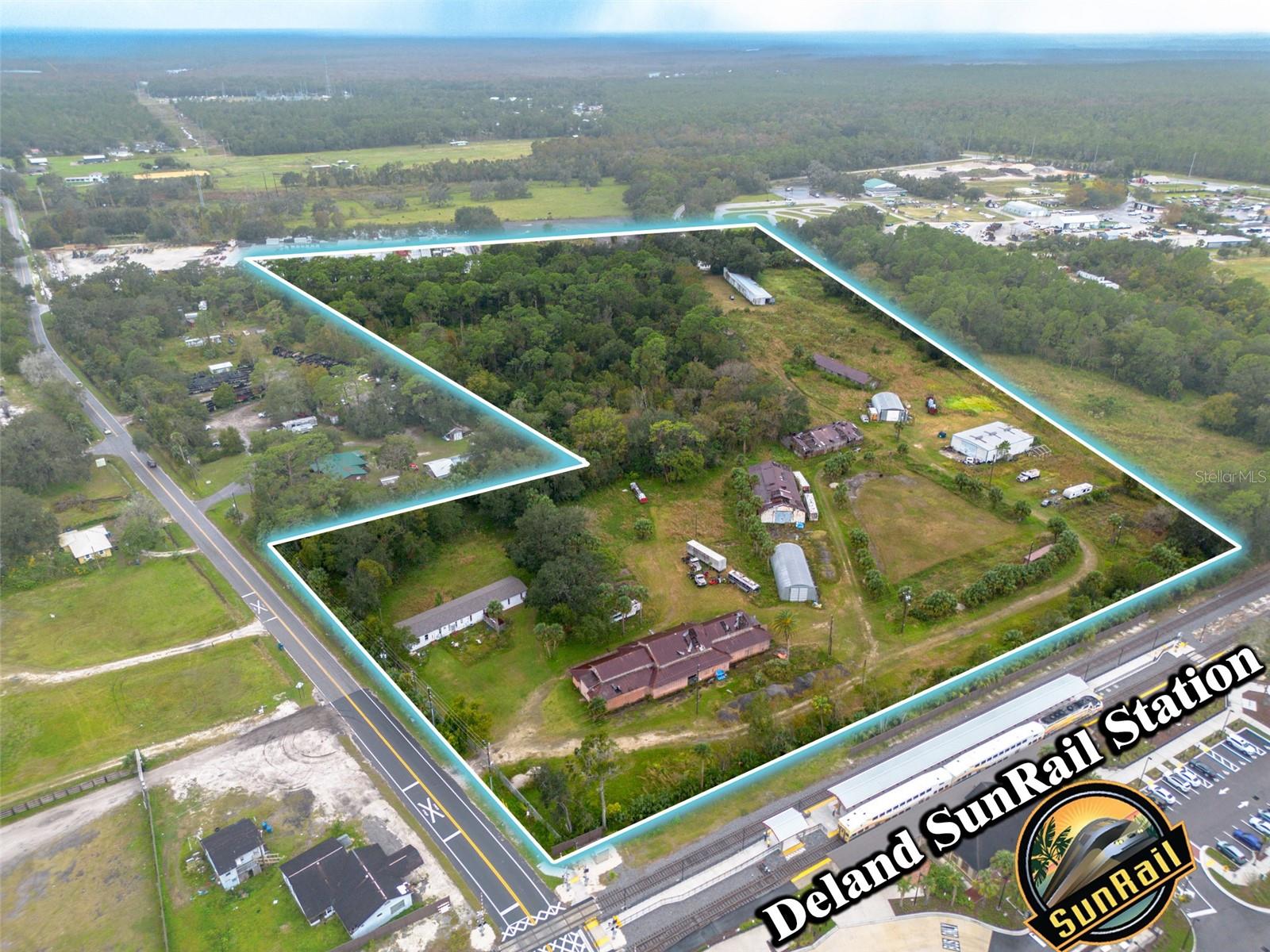 DISCOVER A POT OF GOLD AT THE END OF THE RAINBOW! This 22-ACRE property is located at the Orlando SUNRAIL station in DELAND, FLORIDA (https://www.discoverdeland.org), which has been voted the BEST SMALL TOWN IN AMERICA! Enjoy easy access to Stetson University (with football, baseball, & basketball), Deleon Springs, Blue Springs, and the St Johns River. The SUNRAIL system connects you throughout central Florida, Including Orlando, Kissimmee, with State-of-the-art, multilevel commuter rail cars that ensure safety, comfort, & convenience. This property is equipped with city water & sewer. Block buildings perfect for any Contruction office. Please note some statements here should be verified for accuracy. All information is deemed to be correct but is not warranted!