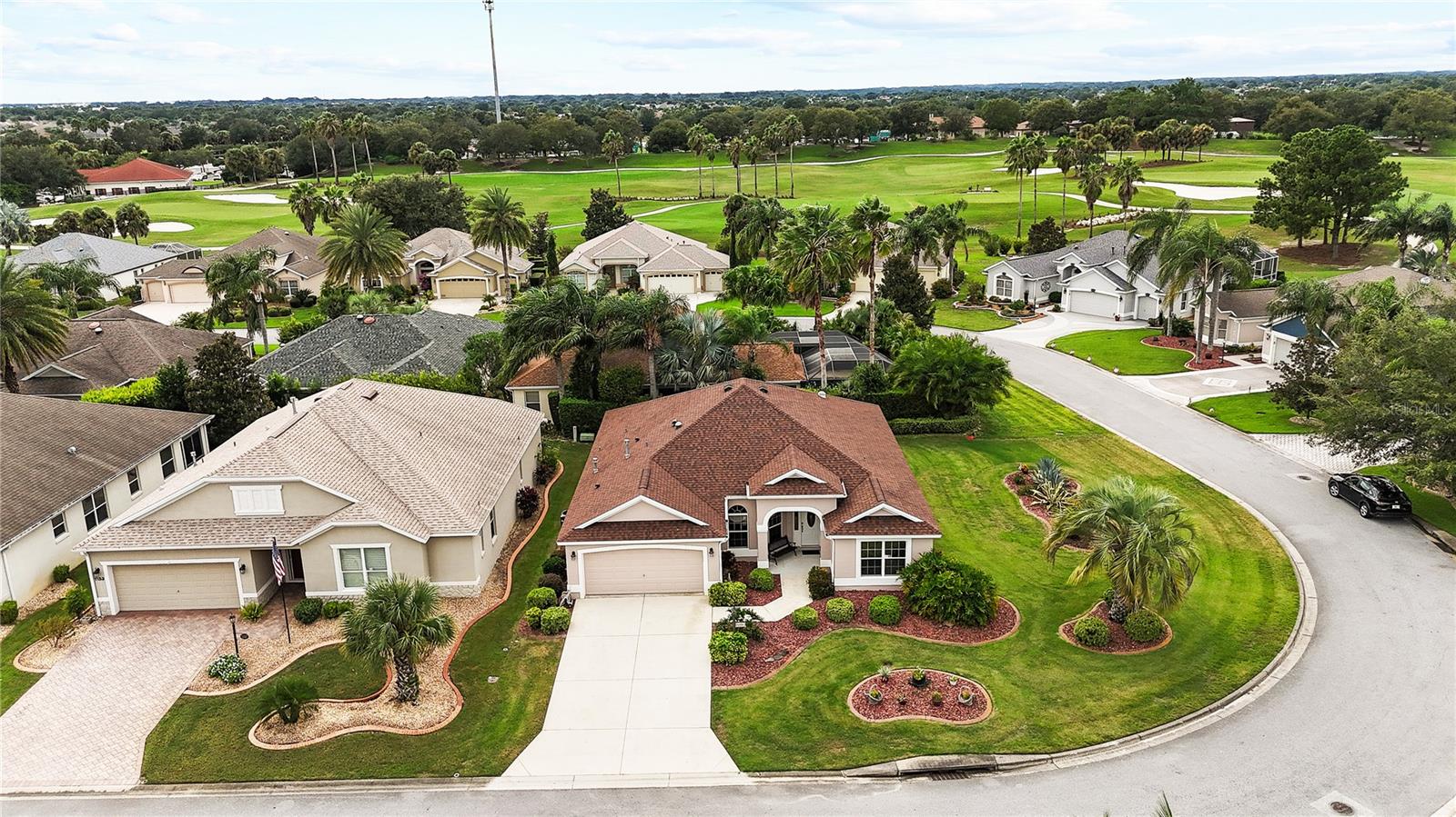 BOND PAID! RARE ALL BLOCK AND STUCCO NEIGHBORHOOD in the Village of Largo! This Gardenia floor plan sits on a desirable corner homesite with plenty of room for a future pool or birdcage. From the moment you arrive, you’ll notice the curb appeal with red lava rock n the flower beds, decorative Curb-It, and landscaping in that frames the home beautifully. Step inside and enjoy volume ceilings, an open split floor plan, and a home so immaculate it has been lovingly nicknamed “Mrs. Clean’s.” The kitchen features White Bay cabinetry, a glass smooth-top range, and crisp Formica countertops. Major updates have already been taken care of, including a roof replacement in 2020, exterior paint in 2025, hot water heater in 2024, dishwasher in 2025, and a sprinkler tune-up in 2023. The enclosed lanai is a great place to unwind after a long day of playing in the community. Tile flows through all wet areas, and the versatile third bedroom without a closet is perfect for an office, den, or guest space. The primary suite offers dual closets and dual vanities. Best of all, this home is located just minutes from Lake Sumter Landing Market Square, where you’ll enjoy nightly live entertainment, waterfront dining, boutique shopping, and the true heart of The Villages lifestyle.