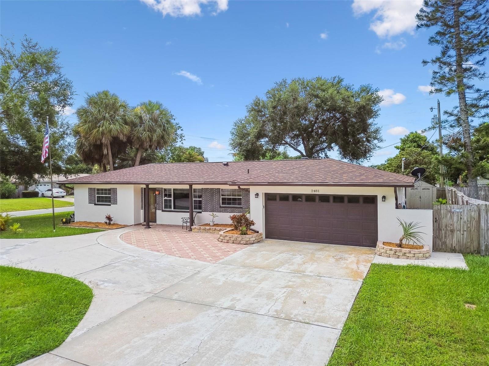 One or more photo(s) has been virtually staged. Welcome to 2481 Burnice Drive in the desirable Tropic Hills neighborhood of Clearwater. This beautifully updated 3-bedroom, 3-bath home in Flood Zone X (non-flood) offers style, comfort, and functionality. Featuring a brand-new roof, tankless Wi-Fi hot water heater, freshly painted interior and exterior, and a versatile permitted office from a partial garage conversion, this residence is truly move-in ready. The split floor plan provides exceptional privacy, with the primary suite tucked away in its own wing. This spacious retreat features a spa-like ensuite bath and a custom walk-in closet. On the opposite side, two additional bedrooms and a bathroom are perfect for family or guests. Designed for entertaining, the open kitchen flows seamlessly into the dining area which boasts a custom built-in dry bar with wine fridge and tons of storage. Two separate living spaces create endless possibilities for relaxation, work, or play. The enclosed back patio with vinyl windows delivers year-round indoor-outdoor living and can easily be conditioned with a mini-split if desired. This enclosed backyard retreat comes complete with a hot tub, bar, and bar seating—ideal for gatherings or quiet evenings under the stars. Beyond the enclosed patio, this backyard is perfect for entertaining with pavered firepit area, storage shed, and is fully fenced for privacy and peace of mind. Situated on a corner lot with a circular driveway, the property offers abundant parking for multiple vehicles, boats, or recreational toys. Garage has partial conversion. Laundry in garage, as well as third full bathroom. Conveniently located off of US 19, near shopping, dining, and Clearwater’s award-winning beaches, this home blends thoughtful updates with a flexible layout to suit every lifestyle.