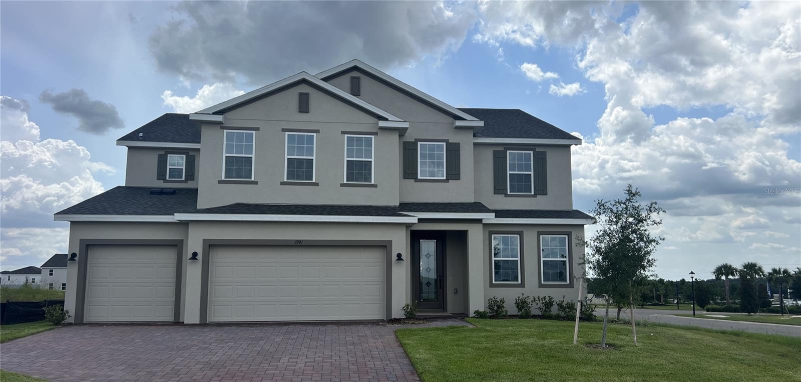 Spacious and thoughtfully designed, this Move-In Ready home offers 6 bedrooms and 4.5 baths, including dual Primary Suites—one on the first floor and one upstairs, each offering a luxurious ensuite Bath —perfect for multigenerational living. Enjoy soaring 9'4" ceilings on the first floor and an open concept layout ideal for modern living. A formal Dining Room welcomes you at the front entry, with a convenient Butler’s Pantry connecting to the expansive gourmet kitchen featuring 42" cabinets with crown molding, large center island, generous walk-in Pantry closet, and stainless steel appliances including a double oven, cooktop, microwave, and refrigerator. The large Great Room opens to a spacious covered rear Lanai, creating the perfect flow for indoor-outdoor entertaining. Upstairs, a versatile Family Room / Loft provides flexible living space for play, work, or relaxation. Trinity Lakes offers exceptional community amenities including Resort style Pool, Splash Pad, Fitness Center, Fishing pier, dog park, and multiple Playgrounds. Close to Schools, shopping and restaurants and conveniently located near major thoroughfares.