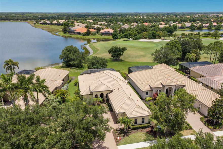 Breathtaking golf and water vistas over Lake Royal and the 14th green in Country Club East reign from this Lakewood Ranch residence positioned off a quiet cul-de-sac showcasing a recently remodeled kitchen, all new porcelain tile flooring, new engineered wood flooring, volume ceilings and even IMPACT windows, doors and sliders throughout. 

Built by Gibraltar Homes with several recent updates including removing entry columns to reveal an expansive 2,479 square foot one-story open plan and a breathtaking outdoor retreat with pavered deck, PebbleTec saltwater pool/spa, panoramic clearview screen, outdoor speakers, pre-plumbed for an outdoor kitchen, and surrounded by premium golf and lake views. 

Seamlessly connecting the outdoor oasis to the oversized great room, kitchen and dining areas are disappearing impact glass doors revealing inspiring 12’  ceilings and a built-in credenza with accent lighting. Meanwhile chefs will delight in the well-appointed new gourmet kitchen updated in 2021 with all new wood cabinetry, soft-close dovetail drawers, new designer tile backpslash, high-performance appliances, sprawling granite and quartzite counters, oversized island, wet bar with wine fridge and two pantries. 

Rest and relaxation beckons in the elegant owner’s retreat offering direct lanai access, engineered wood flooring, oversized customized closet, silhouette remote shades, and a luxuriously appointed spa-like bath with dual sink vanity, make up vanity, inviting soaking tub, and invigorating shower. Family and guests alike will be right at home with two additional guest suites on a separate private wing both with engineered wood flooring centered by an adjoining full bath. This fine residence also offers a private study/den off the foyer with double French entry doors, wood flooring and crown molding and a strategically placed powder room just off the lanai.

Additional notable highlights of this all-encompassing 3,585 square foot residence includes a laundry room with abundant cabinetry and sink, speakers inside and out, 8’ solid interior doors, central vacuum, 2024 water heater, 2025 HVAC, recently painted interior and exterior, a two and one half car garage with electric car charger, and a stunning cul-de-sac location with an inviting gazebo to watch sunsets.

Country Club East provides its residents with the privacy of gated-community living, three community pools, and fitness center, all within a community known for its vibrant Lakewood Ranch lifestyle near dining, shopping, polo, golf, tennis, community events, Waterside Place, Centerpointe, yet still close proximity to the UTC area and beaches of Sarasota. Residents also have the non-mandatory option to become members of the Lakewood Ranch Golf and Country Club, which offers four championship golf courses, two clubhouses, tennis, pickelball, fitness center, heated pools, full social calendar and so much more.