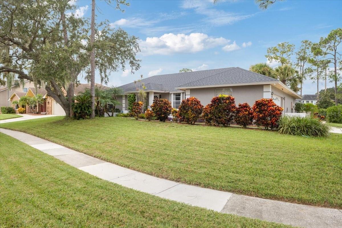 Move-in-ready pool home on a large corner lot in Bay Vista Estates! This 4-bed, 2-bath, 1,874-sq-ft residence pairs fresh renovations with effortless indoor–outdoor living. The 2023 kitchen renovation features a convection oven, microwave, and wine refrigerator, while the primary bath was completely refreshed in 2024. An inviting, open-concept main living area is anchored by a wood-burning fireplace and flows to the screened pool and expansive covered patio. Entertaining is a breeze with an outdoor kitchen (11x10) and an electric pool heater for year-round enjoyment. Practical updates include a 2018 roof, new exterior paint, irrigation system, and an oversized 2-car garage. The second bath offers a convenient tub/shower combo that also serves the pool area. This home has been lovingly curated by the current owners and is waiting to make your forever-home dreams come true. Located conveniently in the heart of Dr. Phillips this home allows for easy access to highly rated schools, restaurants, shopping and community parks. Don't miss the opportunity to make this unique home yours. Schedule your private showing today!