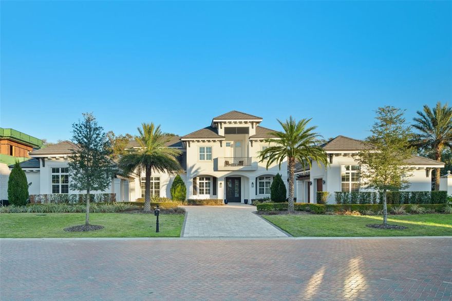 DEEDED, COVERED BOAT SLIP TO THE BUTLER CHAIN OF LAKES!!  Welcome to an unprecedented opportunity in Carmel, Orlando's most exclusive ultra-luxury enclave, where this masterfully crafted nearly new Davila Homes estate—a Parade of Homes Grand Award winner—awaits its second proud owner.
Beyond the stately double doors lies a world of refined luxury, beginning with a sophisticated foyer that makes way into the meticulously designed formal living spaces. Here, volume ceilings soar above the gas fireplace, while an inviting wet bar crafted for entertaining flows gracefully into the space.
The southern wing dedicates itself entirely to owner luxury, featuring an executive home office and a palatial primary suite that redefines personal space. This private sanctuary boasts its own fireplace, sitting area, convenient morning bar, dual walk-in closets, and a dedicated primary laundry room adjacent to the custom walk-in closet. The spa-inspired en-suite bathroom showcases a freestanding soaking tub, dual vanities, and an impressive wrap-around shower that epitomizes luxury.  Step outside to the enclosed courtyard with sleek water fountain feature and outdoor courtyard.
At the heart of this 5-bedroom, 5.5-bathroom residence sits a chef's kitchen worthy of culinary mastery. The space centers around a magnificent 24' x 16' island and features professional-grade stainless steel appliances throughout. A generous walk-in pantry provides abundant storage and prep space for hosting gatherings.
The upper level reveals a spacious loft/game room and three additional en-suite bedrooms. Each bedroom opens to a covered balcony, offering private outdoor retreats with sweeping views.
The outdoor oasis transforms everyday living into a permanent vacation. A resort-style pool forms the centerpiece, complemented by a fully equipped summer kitchen, expansive covered lanai, and an extended paver patio with a fire pit for romantic evening entertainment.
Distinguished features include a private first-floor guest suite, second-floor covered balcony, and a unique courtyard-style driveway leading to split garages accommodating three cars plus a golf cart. The interior showcases a masterful touch of modern elements with every finish carefully curated for sophistication.
Carmel's location in southwest Orlando's Dr. Phillips area offers the perfect blend of seclusion and accessibility. This gated sanctuary of just 11 estate lots sits behind Tibet Pointe's secure gated entrance, just steps from Arnold Palmer's Bay Hill Club & Lodge. The community's western exposure coupled with rare deeded boat slip for permanent access to the esteemed Butler Chain of Lakes, delivers a unique opportunity to enjoy the quintessential Florida lifestyle.
Proximity to Isleworth Golf & Country Club (accessible by boat), award-winning Sand Lake Road dining, upscale shopping, major thoroughfares, and Orlando's famed attractions creates an unparalleled living experience at this prestigious address.