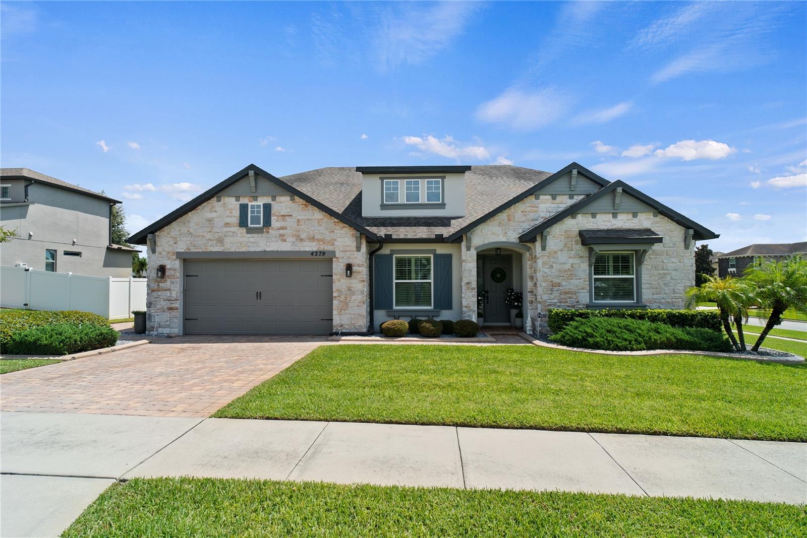 One or more photo(s) has been virtually staged. Welcome home to this stunning pool home designed for entertaining offering nearly 3,000 square feet of living space, a thoughtful split floor plan, and luxury upgrades throughout. As you step through the front door, a private office with French doors and a cozy electric fireplace sets the perfect tone for working from home or quiet study. To the right, two spacious bedrooms and a full bath create an ideal guest or family wing. Gorgeous wood-look tile, laid in a striking chevron pattern, guides you into the heart of the home-an open-concept kitchen, living, and dining area. The chef's kitchen features quartz countertops, a gas stove, and a brand-new refrigerator (April 2025). The primary suite is tucked away for privacy and offers incredible space with three oversized closets. The spa-inspired ensuite bath includes a dual-sink vanity, soaking tub, and a walk-in shower with dual shower-heads and built-in shampoo niches. Step outside and discover your private backyard oasis. The fully fenced yard showcases a heated saltwater pool with PebbleTec finish, a hot tub with waterfall feature, a sun deck, and depths reaching 6.5 feet. Gather around the wood-burning fire pit or entertain in style at the outdoor kitchen, complete with a drink station, wine fridge, refrigerator, and built-in Bluetooth speakers. This home is truly designed for both everyday living and unforgettable entertaining-inside and out.