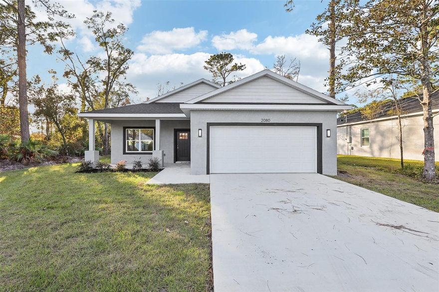 Under Construction. Don't miss this great opportunity to own a brand-new 3-bedroom, 2-bathroom, 2-car garage home located just minutes from beautiful downtown DeLand. This home features an open-concept kitchen with a large island, quartz countertops, and stainless steel appliances including a range, refrigerator, dishwasher, and above-range microwave. The kitchen is highlighted by stunning 42'' upper cabinets, while the main living areas offer stylish vinyl plank flooring and both bathrooms are finished with tile.The spacious master suite includes oversized walk-in closet and a luxurious bathroom with a soaking tub, a beautifully tiled walk-in shower, and double vanities. Throughout the home, you'll find thoughtful upgrades such as ceiling fans in all bedrooms and the living room, 5 1/4'' baseboards, insulated double-pane vinyl-frame windows, and an inside laundry room. Built with quality concrete block and architectural shingles, this home also includes covered front and back porch for added outdoor living space. Some photos may be of previous models finishes and colors may vary.