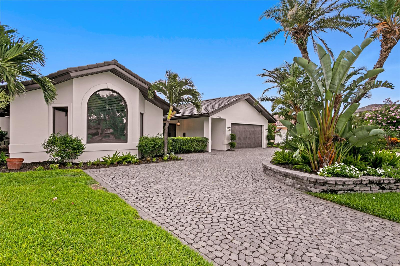 Welcome to the pinnacle of waterfront luxury living in the highly sought-after, deed-restricted community of Venetian Isles. Perfectly situated on an expansive 133 feet of deep sailboat water frontage, this exceptional home offers direct access to Tampa Bay and the Gulf of Mexico with no fixed bridges—making it an ideal setting for boating enthusiasts. Every sunrise brings a new masterpiece across the bay, while cool evening breezes and shimmering city lights of Tampa provide a magical backdrop for coastal living.
A graceful circular Belgium Cobblestone driveway, complemented by lush tropical landscaping and a covered courtyard entry, sets the tone for the elegance that awaits inside. Step into a beautifully designed interior where nearly every room is oriented to maximize the stunning water views. The waterfront living room and the air-conditioned Florida room invite relaxation and effortless entertaining, both overlooking the sparkling swimming pool and open bay beyond.
The heart of the home is a chef’s dream—an exquisitely remodeled kitchen featuring top-of-the-line appliances, a gas stove, custom wood range hood, an oversized center island, and a wine refrigerator. Designed with both functionality and beauty in mind, the space is perfect for preparing meals or gathering with guests in comfort and style.
The expansive master suite is a true retreat, offering two spacious walk-in closets (including one large enough to serve as a nursery, office, or gym), a massive sitting area, space for a wet bar, and a wall of glass that captures sweeping, uninterrupted views of the bay. It’s a personal sanctuary where you can wake each morning to the tranquil beauty of the water.
Outdoors, enjoy a resort-style experience with a pristine swimming pool, covered alfresco dining area, and a private dock that stretches into the bay. The wide seawall adds to the sense of openness and security, while the dock is ideal for launching your boat or simply enjoying the peaceful ambiance of life on the water.
Renovated to perfection and offering remarkable water views from multiple rooms, this home is ideally located just minutes from downtown St. Petersburg. Whether you choose to arrive by bike, golf cart, or boat, you’ll enjoy easy access to award-winning dining, arts, and entertainment. The proximity to I-275, Tampa International Airport, and our world-famous white sand beaches ensures that convenience matches luxury at every turn.
This is more than a home—it’s a waterfront lifestyle unmatched in beauty, comfort, and location. Come discover why so many choose to call Venetian Isles home. *The Allstate flood insurance is assumable @ roughly $900 a year. See attachments.