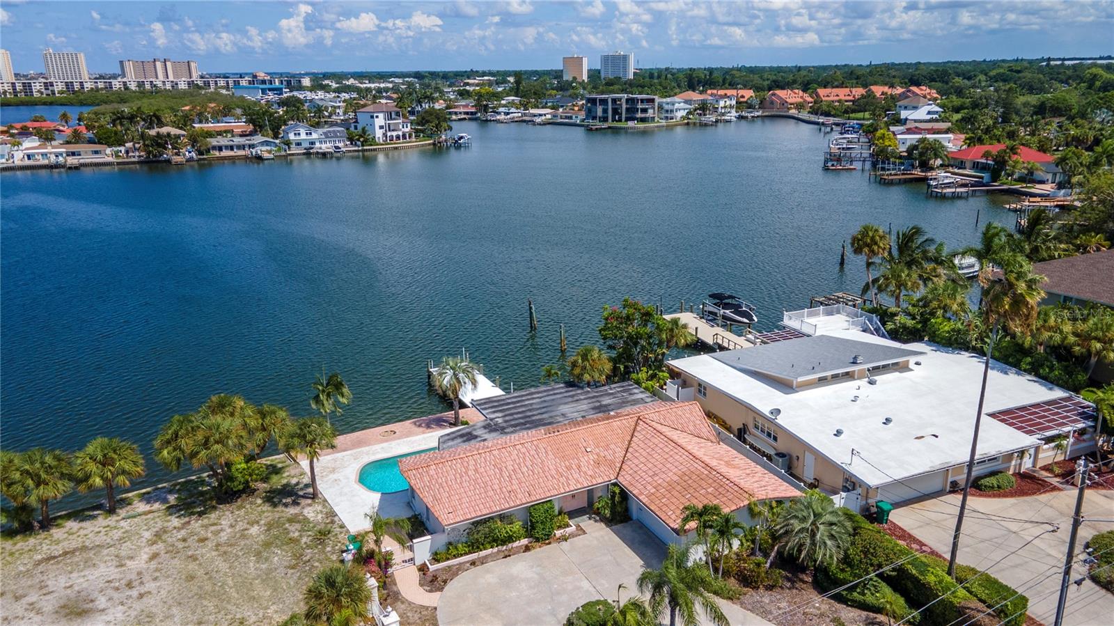 Under contract-accepting backup offers. If you are looking for waterfront property, your search is over! This property is being sold as a package with the adjacent empty lot, please see MLS # U8250544. Your options are endless: you can live in the existing house and build on the adjacent lot, knock down the current house and combine both lots for a larger estate, or build on both lots. The seller will not be making any upgrades, as the property is being sold as-is. The sunsets from your back patio are breathtaking, offering a perfect end to each day. The seawall on each lot is approximately 93 feet & 5 inches long.
