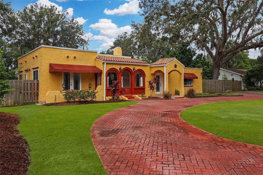 Welcome to an enchanting Mediterranean revival masterpiece nestled within the prestigious community of Temple Terrace Estates. This exquisite historic residence exudes timeless charm and is set on a sprawling .27-acre lot adorned with mature fruit trees and captivating Natchez Crpe Myrtle Trees. Impeccably constructed in 1926 by the visionary architect Dwight James Baum, renowned for crafting the opulent Ca' d'Zan palace of John Ringling in Sarasota during the early 1920s. Step inside through the beautiful front entrance to be greeted by the allure of Saltillo tile entries, seamlessly transitioning into the original oak and hardwood pine floors gracing the main living areas and bedrooms. Indulge in the luxury of a thoughtfully designed split floorplan, providing a serene retreat with the master suite occupying the right wing, while two additional bedrooms await on the left. This exceptional home beckons you to move in effortlessly and relish in its timeless elegance. The heart of this remarkable home boasts an inviting dining and living room adorned with a functional fireplace, perfect for intimate gatherings. Open the French doors that grace the dining room and step out onto an expansive deck, commanding panoramic views of the generous, privately fenced rear yard. Adjacent to the dining room, discover a meticulously adorned walnut-toned kitchen with exquisitely matched granite counters. The kitchen also boasts a cozy breakfast nook, providing a tranquil space to enjoy a morning coffee. The master suite is a haven of relaxation, featuring a luminous ensuite bath with a walk-in travertine shower, glowing with natural light. The secondary bedrooms exude charm and offer ample space with their gracefully appointed cedar wood closets. They effortlessly access the hall bath, which showcases a restored oversized bathtub and shower, boasting original tile flooring. Beyond the main dwelling, revel in the convenience of a horseshoe driveway at the front of the property. Additionally, a detached 185-square-foot exterior building awaits, providing a versatile space ideal for a home office or studio. This building also features a laundry room equipped with the home's water softener system and tankless gas water heater. Other important upgrades include: a full yard irrigation system, updated hurricane-strength glass windows (2011), newly painted interior (2023), updated Electrical wiring in 2011, and a PTO Commercial grade roof installed in 2015! This home offers the perfect blend of natural beauty with stunning landscapes, neighborhood river views, and majestic oak trees. Its central location grants easy access to renowned beaches within an hour's drive and a short 30-minute journey to Tampa International Airport. Enjoy vibrant local amenities, including the prestigious Temple Terrace Golf and Country Club. Proximity to USF, Advent Hospital, the VA, Moffitt Cancer Center, and other medical facilities ensure the ultimate convenience. New homeowners receive a complimentary 3-month social membership to Temple Terrace Golf and Country Club for exceptional amenities and social opportunities. This remarkable residence boasts an array of fruit trees, including Jaboticaba, Pomegranate, Avocado, Pear, Mango, Starfruit, and Fig. Experience the enchantment of a home that seamlessly combines timeless elegance and modern amenities, offering an unparalleled living experience filled with natural splendor, history, and comfort.