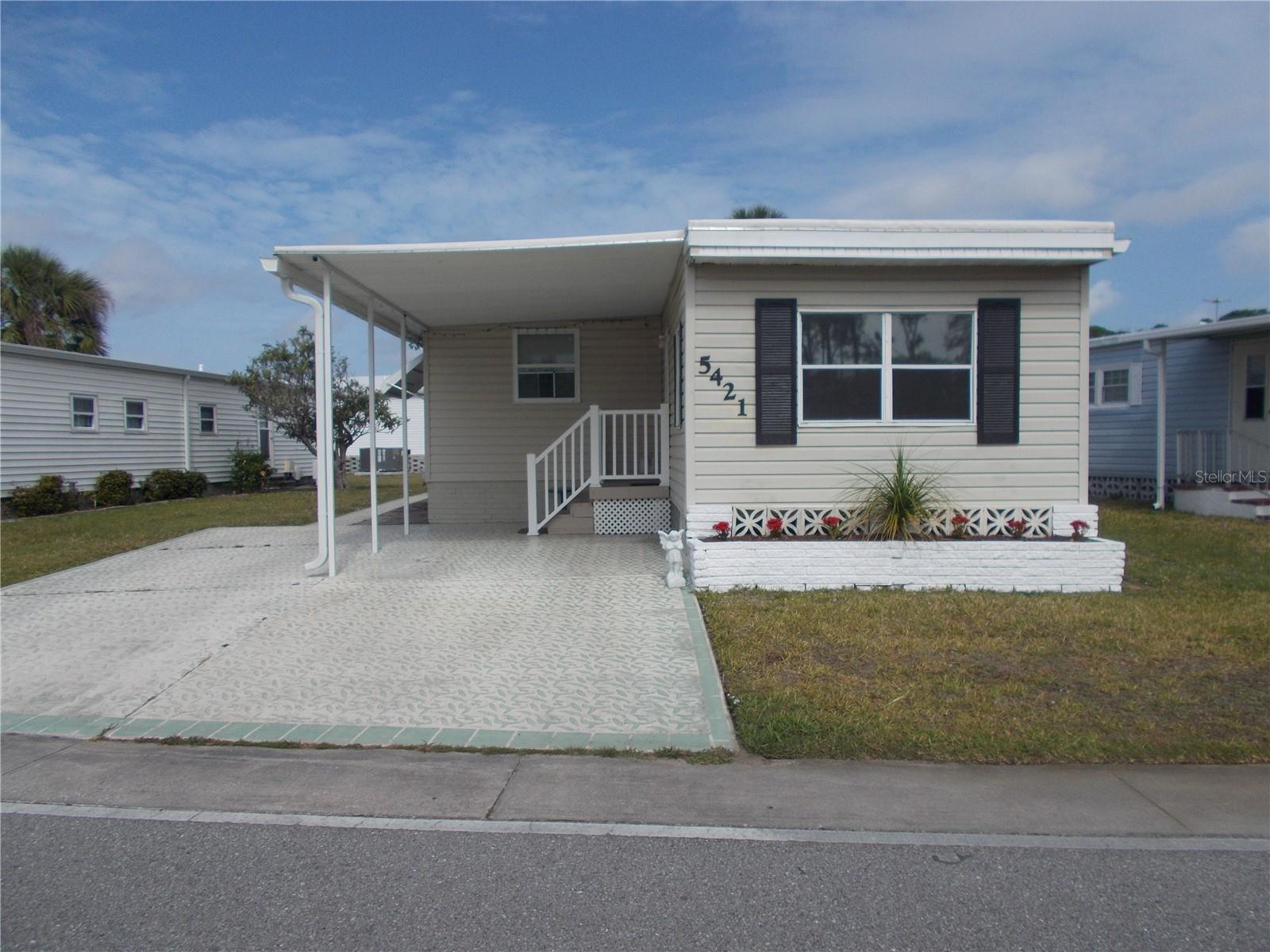 JUST REDUCED!!!This is a 2 Bedroom, 1 Bath home, not in the Pet Section. You have a Living Room and a bump out that is used as the Dining Room. It has a large Bonus Room which is off the Dining Room and has a door to the back. Your primary bedroom is in the back of the house and the bathroom has a shower. You have 2 parking pads in the front. The 10 X 25 shed has the washer and dryer. In Holiday Park you own the land with a deed and your $195.00 monthly maintenance fee ($2340.00 a year) is included in your taxes. The community features 2 clubhouses, 2 swimming pools, a library, a fitness room, tennis courts, pickleball & bocce courts, to name a few. You are close to shopping, dining, entertainment, numerous golf courses, sports facilities, and SW Florida's renowned beaches. Come take a look!