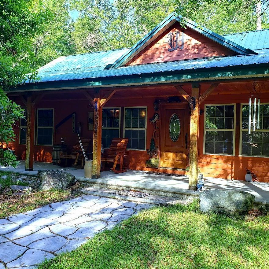This is truly a once in a lifetime cabin. Custom built with extensive woodworking that you don't see every day on almost 5 acres located within a half mile from the Ichetucknee River that allows you three private entrances to the river for tubing and a private boat ramp. Deer are a daily enjoyment, while listing this home I was pleasantly greeted by them. When you walk in the front door you will be overwhelmingly surprised with the craftsmanship of wood and all the extras. The kitchen was thoughtfully planned to bring out the chef in you. The sizeable master retreat with custom made bed, the two-person jacuzzi. and the steam shower will be the hit of your day. The living area is very spacious with plenty of room for friends and family to gather. The handcrafted fireplace can be enjoyed in the family room as well as the master suite.  You will find breathtaking views from every window in the home. Upstairs there is an additional space that can be turned into a 3rd bedroom or office, loft etc. it is fully wired and ready for drywall. The home is being sold turnkey, so put this on your must-see list today as you will not be disappointed.