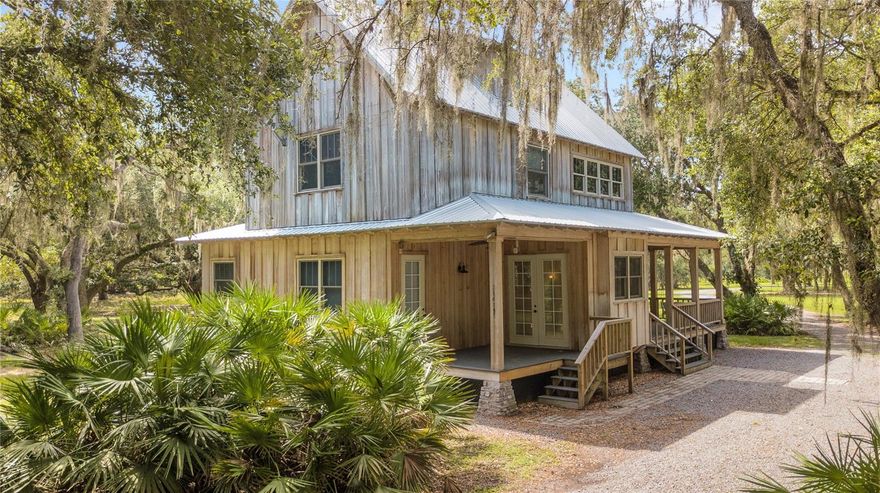 This secluded lakefront three-bedroom estate with a detached garage/guesthouse is located on 4.83 acres and nestled on the shores of Lake Kissimmee, nationally renowned for bass fishing and ideal for boating and canoeing. Quiet and peaceful, this wooded property is custom built by Ernie White. Privately gated entrance, 5-mile graded access, maintained by the Forestry Division and, abuts the Forestry and Southwest Florida and Water Management District. One of the many property highlights is the 150 feet of lakefront access, a private 200-foot dock with a boathouse and lift, as well as water and electric. The main home features two bedrooms, two full and one half bathrooms, a great room with a gas fireplace, a dining room and kitchen, and a finished attic with a possible third bedroom/game room, as well as plenty of storage space. The detached two-car garage has 689 square feet plus a half bathroom and laundry room. Garage Second story includes a spacious guesthouse of 938 square feet of living space; and includes a family room, kitchen, breakfast nook, one-bedroom and a full bath. Check out a video tour here: https://vimeo.com/840425301