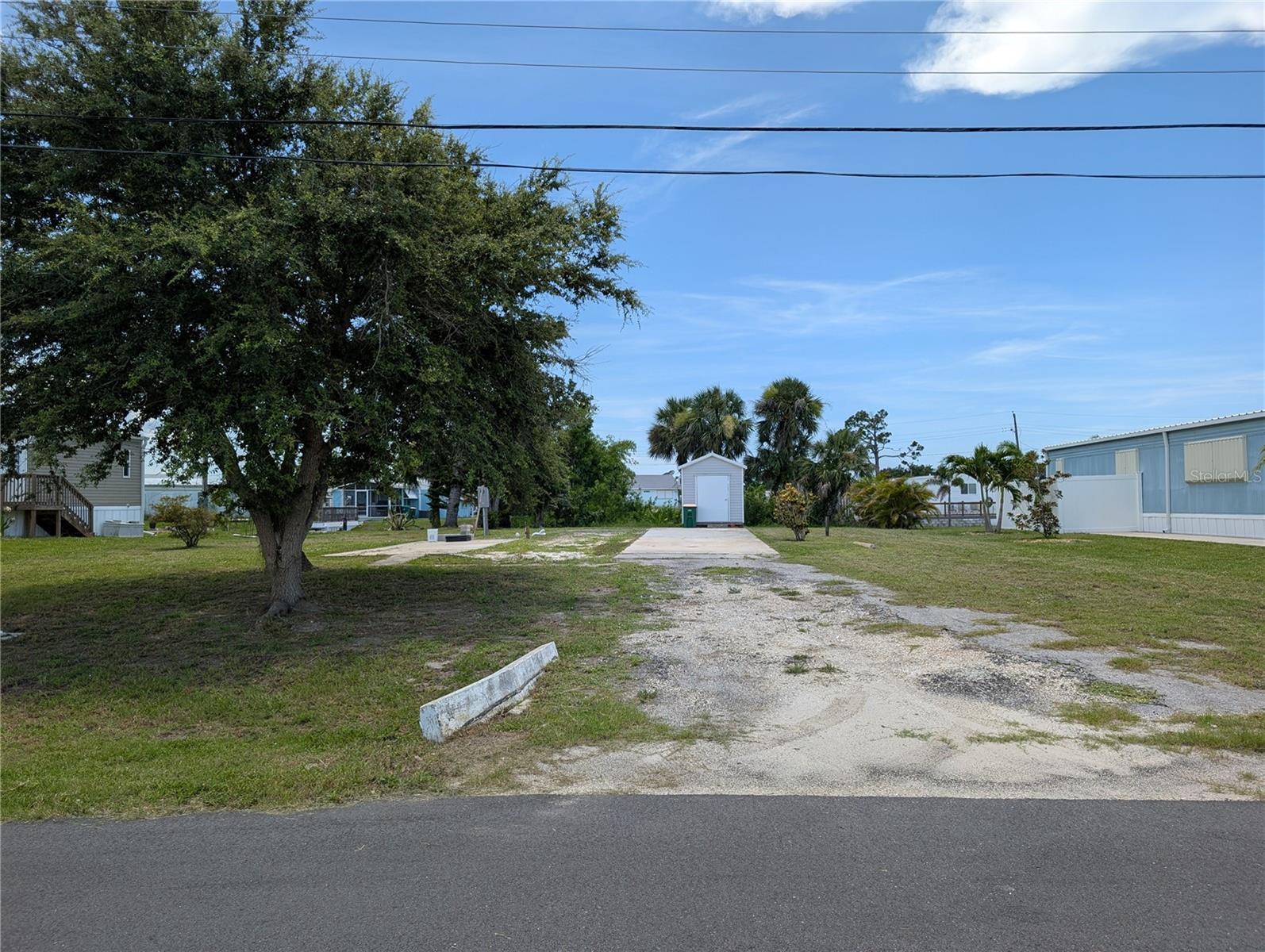 Welcome to Mobile Gardens, a peaceful and well-located 55+ boating community in the heart of Englewood! This cleared and ready-to-build mobile home lot sits just steps from the community private boat ramp with direct access to Oyster Creek and the Gulf of America—only one bridge out to open water! Enjoy water views and the convenience of an active water meter and electric available, saving you time and money from the start. There is no mandatory HOA, but for a low optional fee, you can enjoy community amenities like the clubhouse, shuffleboard courts, planned social events, and available first-come, first-served boat slips. Located just blocks from SR 776 and minutes from restaurants, shopping, golf courses, Boca Grande, Manasota Key beaches, and even two MLB Spring Training stadiums, this property offers it all. Whether you're seeking a seasonal retreat or a full-time Florida lifestyle, this lot is the perfect blank canvas. Bonus: the shed conveys! Don’t miss your chance to create your ideal Gulf Coast getaway in Mobile Gardens.