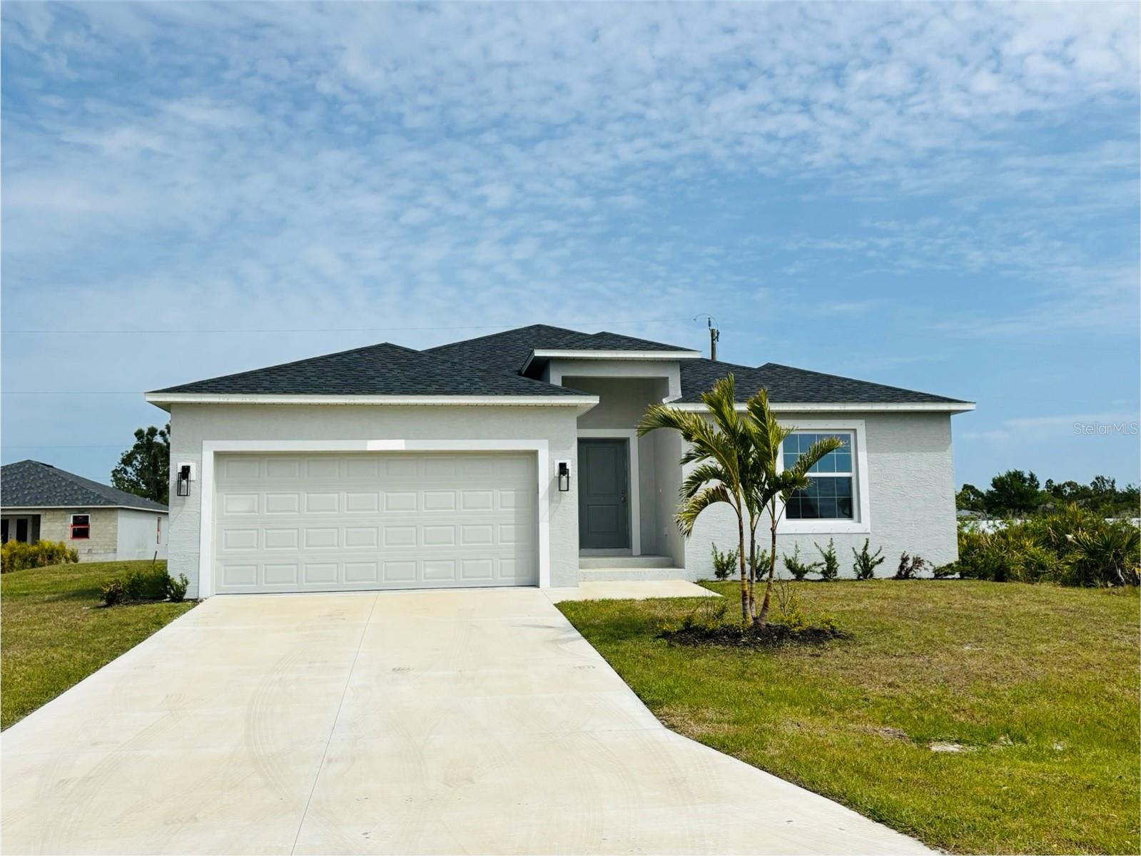 Under Construction. Beautiful Brand New Home!!!Under construction!! The Seabreeze Model is a wonderful home design encompassing 3 bedrooms, 2 baths, and a 2 car garage across 1,606 sq. ft. of living space. The open kitchen includes a walk-in pantry, spacious island, breakfast/dining area, and French Doors leading to the lanai. The master bedroom includes a walk-in closet, walk-in shower, and dual sink vanity. The remaining 2 bedrooms are located by a secondary bath which includes a shower. The home features cathedral ceilings, wood look tile throughout, granite countertops in the kitchen and bathrooms, recessed lighting, ceiling fans in every room, and stainless steel appliances. The home comes with hurricane/storm shutters. There is no wasted space in this home as it was designed for the discerning buyer who is looking to live the Florida lifestyle. Stop by today to see this beautiful home! PLEASE NOTE - the pictures for this listing are representative of the subject home prior to construction.