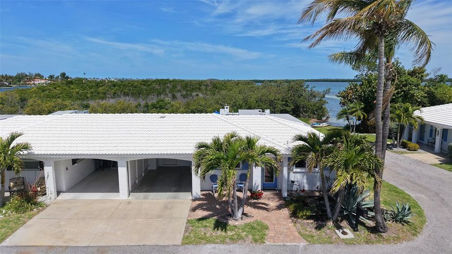 Wow! Panoramic water views from almost every window, plus rare direct access to Bay waters just steps from the back paver patio. This completely renovated 2 bed/2 bath, 1449 sq. ft home is a must see! Fully remodeled in 2025/2026 in full compliance with FEMA requirements. It is all about the details as this gorgeous Spanish Main turn-key furnished villa is ready to welcome you home! The centerpiece of the kitchen is the very large strategically custom designed Quartz island that doubles as a dining table, in a soft color palette that can seat 10. The kitchen features beautiful all wood 42” cabinetry, stainless steel appliances, large undermount sink with a push button garbage disposal, lovely backsplash and lots of storage with an abundant of additional counter space, perfectly designed for entertaining. The villa flows seamlessly with an expansive open floor plan, plank tile flooring in every room plus crown molding that frames each room. The large primary bath has an oversized classically designed walk-in shower created for handicap access with double sinks. The tastefully appointed guest bath has an all-glass enclosed walk-in shower. From guest bath, enter the 9X6 in villa laundry room with new stacked Electrolux washer and dryer. All hurricane grade windows and doors to secure the home from the Florida storms. Custom window shades provide sun mitigation and ultimate privacy. The fully enclosed glass Florida room is a treasure in and of itself with extensive views of Sarasota Bay with a lush backdrop providing total privacy. There is also a built-in office space, large walk-in closet, additional flex space for dining and/or lounging plus a dry bar and wine center which makes this a very useful space. Step outside onto the brick paver patio and lounge, grill and relax with the sound and views of the Bay waters and abundant bird and wildlife. Grab your kayak or paddleboard and launch right from the backyard with direct water access to the open Bay waters. This villa is packed with so many upgraded features with new tile roof in 2019, A/C 2020, and tankless hot water in 2018. The villa is part of the Spanish Main Yacht Club community which has some of the best waters to explore in Sarasota for fishing, sandbar enjoyment, kayaking and swimming right in your own backyard. You have direct access to the Intra-coastal waterway and a quick boat ride to the Gulf of Mexico with restaurants you can get to by boat. The Spanish Main maintenance free- community has a wonderful neighborhood feel with a heated pool overlooking the 40-slip Marina, deeded beach access, with social events galore making every day feel like a vacation as you lounge in the sun and enjoy the sea breeze. Slips are available for very affordable leasing. The deeded beach access is perfect for those numerous beach days and magnificent sunsets. This pet-friendly very active 55+ community are added benefits for your enjoyment. Located only a short drive to the fantastic shops and restaurants including Anna Maria Island plus cultural events that Sarasota and St. Armand’s Circle have to offer.