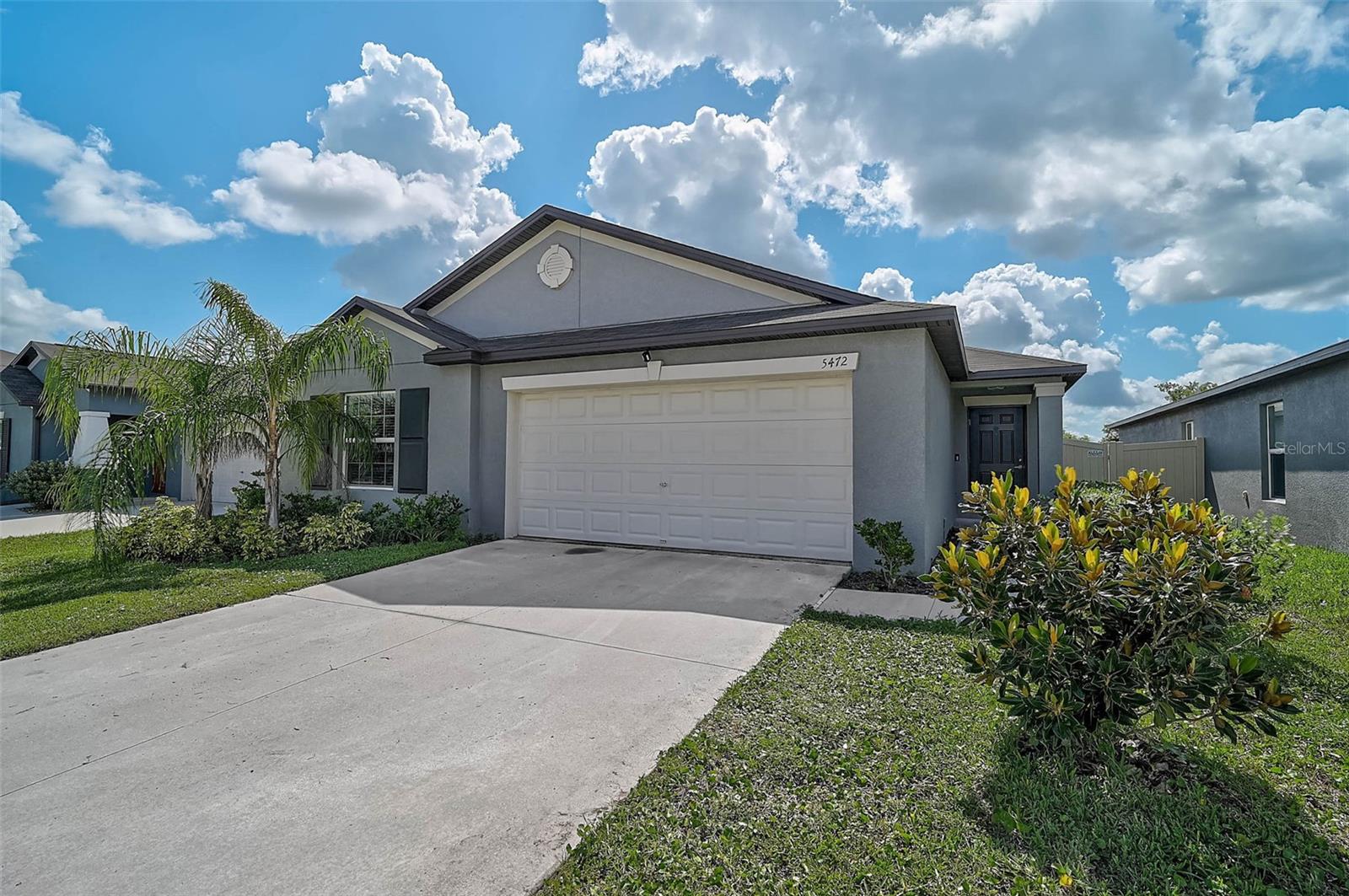 Built in 2022, this single-story 1,841 sq ft home delivers seamless, modern living with a thoughtful split-bedroom design. An airy, open-concept great room connects the kitchen, dining, and living areas for easy everyday flow and effortless entertaining. Three secondary bedrooms sit behind the kitchen in their own private wing—ideal for guests, office, or playroom—while the expansive primary suite is quietly set in the back corner, a peaceful retreat with backyard views. Outside, enjoy a large, privacy-fenced backyard with room to relax, play, or garden. Move-in ready and designed for convenience on Blue Azure Drive.