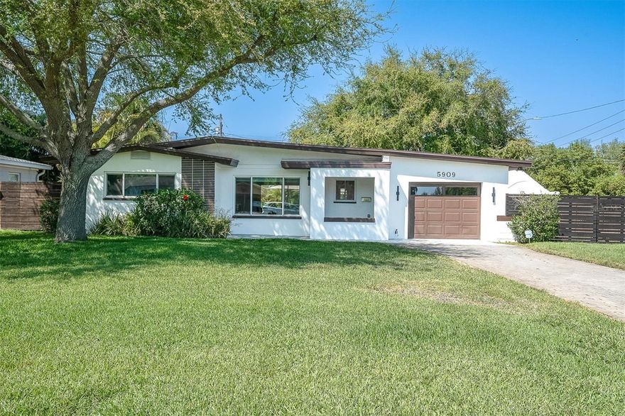 Step into timeless style with this authentic Mid-Century Modern 2-bedroom, 2-bath block home—perfectly blending classic design with today’s must-have updates. Located in a no flood zone and thoughtfully upgraded throughout, this property offers true peace of mind with a new roof (2024), impact-rated windows and sliders, a custom front door, and a 2022 AC system.  Situated on a desirable corner lot, the property features a huge fenced yard (2024), mature landscaping, and plenty of space for all your lifestyle needs—including boat or RV parking. The outdoor living is a true highlight, with an expansive paver patio, covered and screened lanai, and a stunning saltwater pool with a 2023 system—perfect for relaxing or entertaining year-round.  Inside, the home blends classic design with modern upgrades. The updated kitchen features quartz countertops, Whirlpool Gold Series stainless steel appliances, and generous storage. A spacious living and dining room combo is enhanced by a custom soundproof accent wall with theater lighting, creating a unique and inviting atmosphere. Tile flooring throughout adds durability and a clean, cohesive look.  The oversized primary suite is a true retreat, complete with a walk-in closet featuring quartz built-ins and a beautifully updated ensuite bathroom with a double vanity and a sleek glass-enclosed rainfall shower. The second bedroom is generously sized with dual closets, and the home offers ample storage throughout. Additional features include an oversized one-car garage, paver driveway, and a new custom front door that enhances curb appeal. Ideally located just 10 minutes to Treasure Island Beach and 10 minutes to Downtown St. Petersburg, this home offers the perfect combination of character, updates, and convenience.