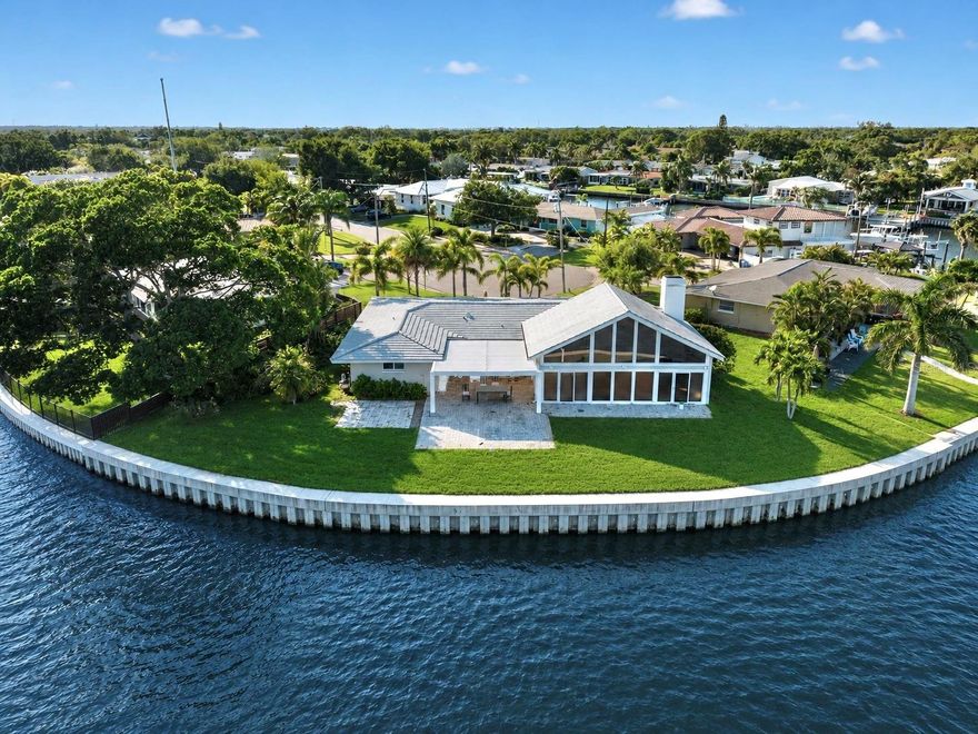 One or more photo(s) has been virtually staged. Positioned on an extraordinary oversized pie-shaped homesite along the coveted waters of Smacks Bayou, 1276 37th Ave NE represents a truly rare opportunity to secure one of the most compelling waterfront parcels to hit the Northeast St. Petersburg market in recent memory. With an astounding 144 feet of seawall and sweeping panoramic water views, this exceptional property offers the canvas to create a landmark legacy estate in one of Tampa Bay’s most desirable waterfront settings. Encompassing approximately a quarter acre of prime waterfront land, the property presents limitless possibilities for the visionary buyer, developer, or end user seeking to design a truly spectacular custom residence with dramatic water frontage rarely found at this scale. The unique pie-shaped configuration creates an expansive rear waterfront footprint that maximizes view corridors, outdoor living potential, and the ability to craft an architectural masterpiece that fully embraces the beauty of its surroundings. The existing residence—a solid block construction home—offers the flexibility to either renovate and reimagine the current structure or start fresh with an entirely new luxury waterfront estate tailored to the most discerning tastes. Inside, the home features generously scaled entertaining spaces accented by soaring vaulted ceilings, a wet bar, a wood-burning fireplace, and timeless Spanish tile flooring that collectively create a warm coastal ambiance filled with character and potential. Additional highlights include a two-car garage, tile roof, water filtration system, and select impact-rated windows already in place. What truly separates this offering, however, is the irreplaceable combination of lot size, water frontage, and commanding open water views. Properties with this level of scale and waterfront presence are becoming increasingly scarce throughout Northeast St. Petersburg, making this an exceptional opportunity to secure a premier piece of Tampa Bay waterfront real estate with unlimited upside. Whether your vision is a sophisticated modern coastal compound, an iconic Mediterranean-inspired estate, or a timeless architectural showpiece designed to span generations, 1276 37th Ave NE offers the setting, scale, and prestige to bring that vision to life.