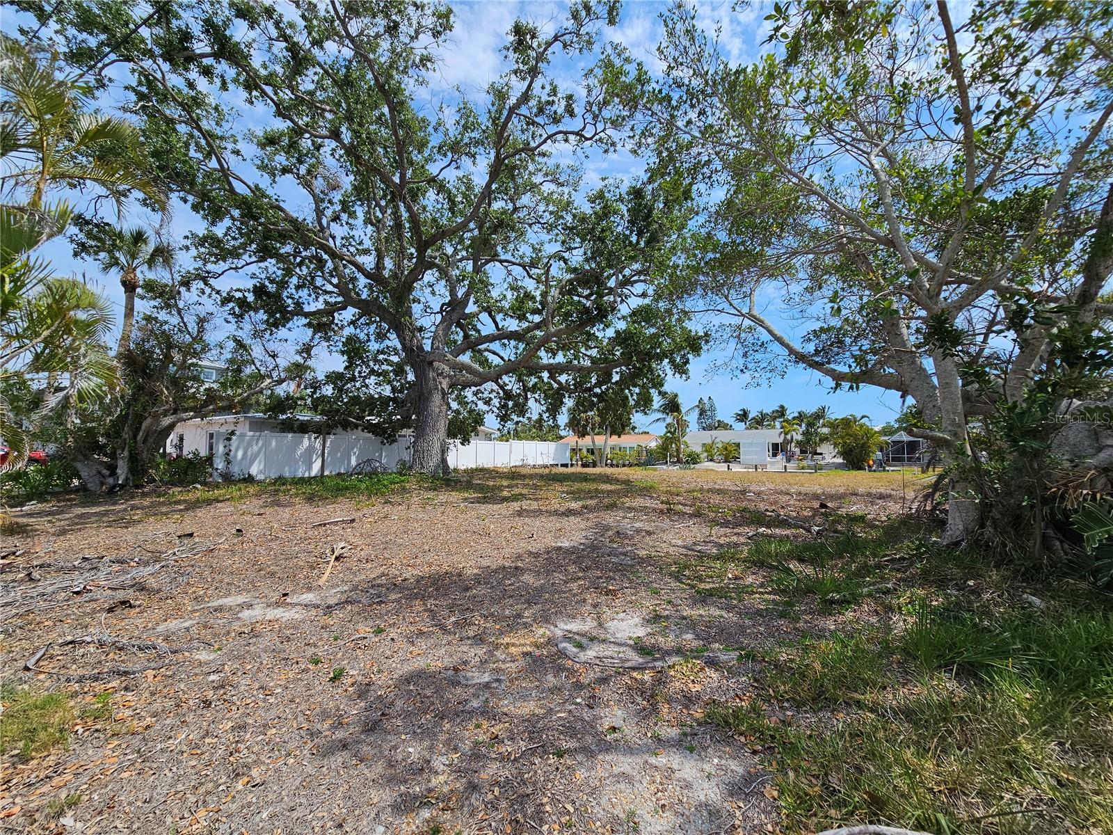 20% Down Seller Financing Offered. Design Your Legacy on Siesta Key – Premier Waterfront Lot in Siesta Manor
Welcome to Lot 17 on Avenida Leona—an extraordinary opportunity to create your own masterpiece in one of Florida’s most coveted coastal enclaves. Nestled along a private, tree-lined lane in Siesta Manor, this canal-front parcel offers the rare combination of deep water access, walkability to Siesta Key Village, and the serenity of a tucked-away residential setting. Spanning .183 acres, this build-ready lot offers 64 feet of seawall-lined frontage on a peaceful boating canal, granting direct access to the shimmering Intracoastal Waterway and beyond. Whether your dream home includes a sleek infinity-edge pool, a private dock for sunset cruises, or a lush tropical garden oasis, this lot provides the perfect canvas for refined waterfront living. Step outside and find yourself just moments from the soft quartz sands of world-famous Siesta Beach. Stroll to the vibrant Village for gourmet dining, boutique shopping, and a lively arts scene—all while retreating each evening to the tranquil rhythm of the water and the gentle call of seabirds overhead. As Sarasota continues to rise as one of the nation’s premier luxury destinations, Siesta Key remains its crown jewel—where timeless beauty, natural splendor, and elevated lifestyle converge. Whether you’re envisioning a coastal escape or a showstopping modern estate, Lot 17 is your blank slate in paradise. This is more than just land—it’s your legacy in the making.