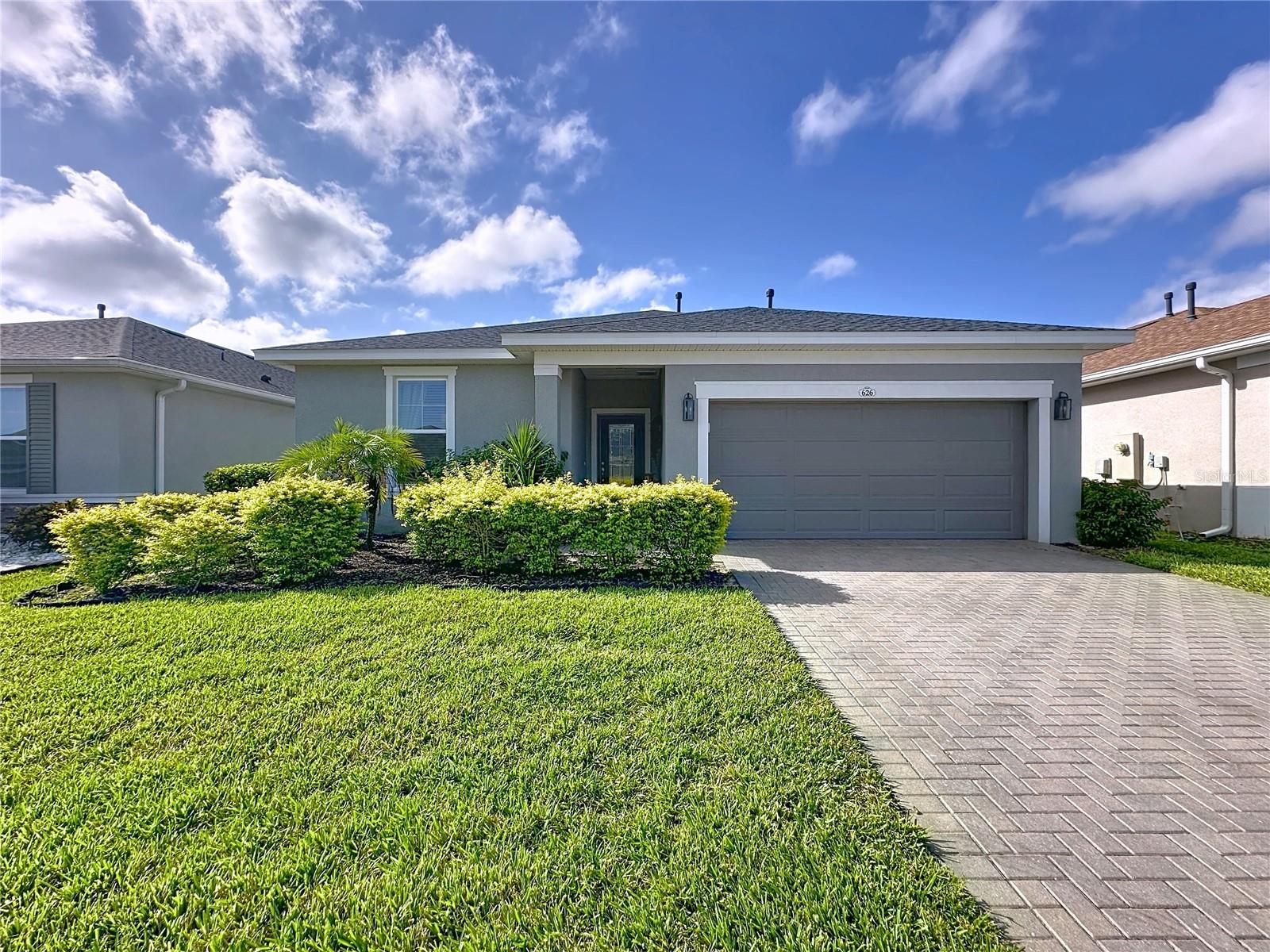 *GUARD-GATED RESORT LIVING!* Discover the perfect home in the perfect community of Trilogy where lifestyle and comfort meet. This *OPEN-CONCEPT, SPLIT-FLOOR PLAN* features *3 BEDROOMS PLUS A VERSATILE FLEX ROOM*, ideal for office, hobby, or guest space. The heart of the home is the *CHEF'S KITCHEN* with a *HUGE QUARTZ-TOPPED ISLAND*, an abundance of crisp *WHITE CABINETRY, GAS COOKING*, and all appliances included. Enjoy easy living with *WOOD-LOOK TILE THROUGHOUT (NO CARPET!)*, expansive windows, and energy-efficient upgrades like *LOW-E DOUBLE PANED WINDOWS* and *NATURAL GAS*. The *PRIMARY ENSUITE* offers true retreat living—*DUAL SINKS, WALK-IN SHOWERS, PRIVATE COMMODE, LARGE WALK-IN CLOSET, and LINEN STORAGE*. Covered lanai, Garage has an extra are for storage or workbench. Set *HIGH ONN THE HILL*, this property showcases an *EXPANSIVE, LANDSCAPED BACKYARD VIEW*, creating the perfect setting. Community Perks: This guard-gated, resort-style community offers more than just home, it delivers a lifestyle! The HOA covers cable, high-speed internet, security monitoring, and landscaping/ lawn care so you can focus on enjoying your time. At the heart of it all is the spectacular 57,000 sq ft Magnolia House, where you’ll enjoy Member-exclusive restaurant and bar with live entertainment. Indoor/outdoor heated pools & a state-of-the-art athletic club Artisan studio, poker room, culinary kitchen, and creative spaces. Sports courts for tennis, pickleball, bocce, billiards & virtual golf,50+ active, member-led clubs for every hobby and interest. A show-stopping Event Center with a stage and professional AV setup. This isn’t just a home, it’s a lifestyle upgrade where you’ll find connection, wellness, excitement, and belonging every day. Conveniently located 45 minutes to Theme Parks including Universal and Disney World and Orlando International Aitport, 1 ½ hour to Beaches and Port Canaveral Cruise Terminal. This isn’t just a home — it’s a lifestyle upgrade. Live your BEST LIFE at Trilogy! Also the new flyer that we are attaching.