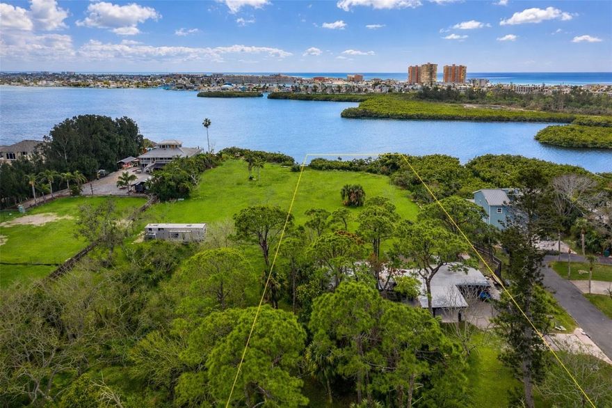 Welcome to a truly rare opportunity in the heart of Seminole. Situated on an expansive 2.87 acres of waterfront land, this exceptional property at 13798 74th Ave offers the perfect blend of privacy, space, and location — something that is increasingly difficult to find in Pinellas County. Located in a highly desirable area of Seminole, this property is just minutes from top-rated schools, shopping, dining, and only 5 minutes to the Gulf beaches, allowing you to enjoy coastal living while still having the freedom of a large estate-style setting. Positioned in an unincorporated area, this property offers flexibility and opportunity for those looking to build their dream home exactly to their vision. With nearly three acres at your disposal, the possibilities are endless — whether you envision a private family compound, luxury estate, or a custom home with room for additional structures, gardens, or recreational space. A standout feature is that the property is zoned for horses, making it ideal for equestrian enthusiasts or anyone seeking a lifestyle with more land and fewer restrictions than typical residential parcels in the area. The seller has already completed extensive permitting work with the county regarding the waterfront, including steps toward installation of a dock. While the water would need to be dredged to accommodate boat use, much of the groundwork has already been addressed, offering significant value and saving future owners time and effort. Large waterfront parcels of this size in Seminole are extraordinarily rare. Opportunities like this almost never become available, especially in such a central location close to the beaches. Whether you’re looking to build now or secure a long-term investment in one of the area’s most desirable locations, this is a property that truly stands apart. Don’t miss your chance to own one of Seminole’s most unique waterfront land offerings — properties like this don’t last.